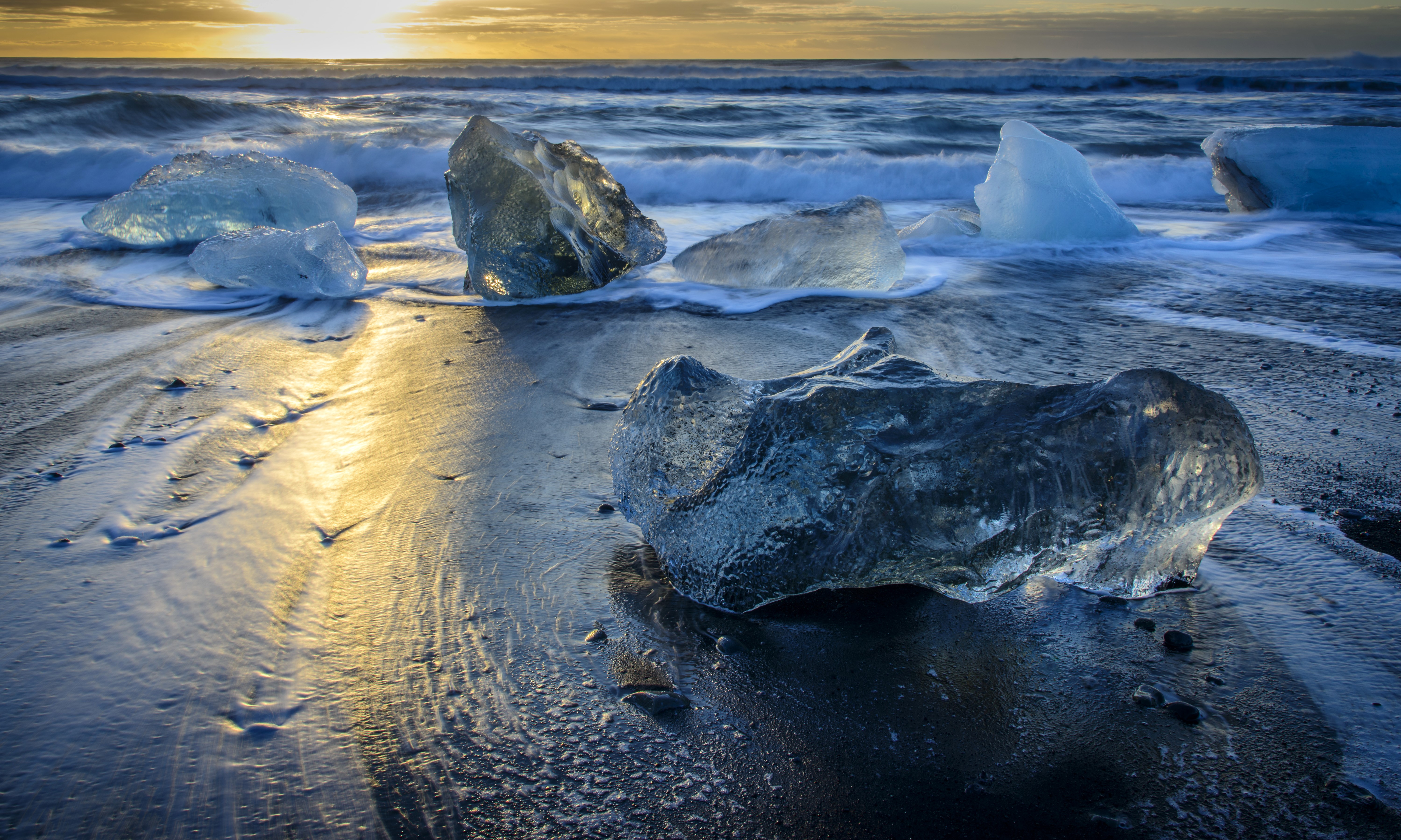 Icebergs on black sand beach in Iceland at sunset HD Wallpaper