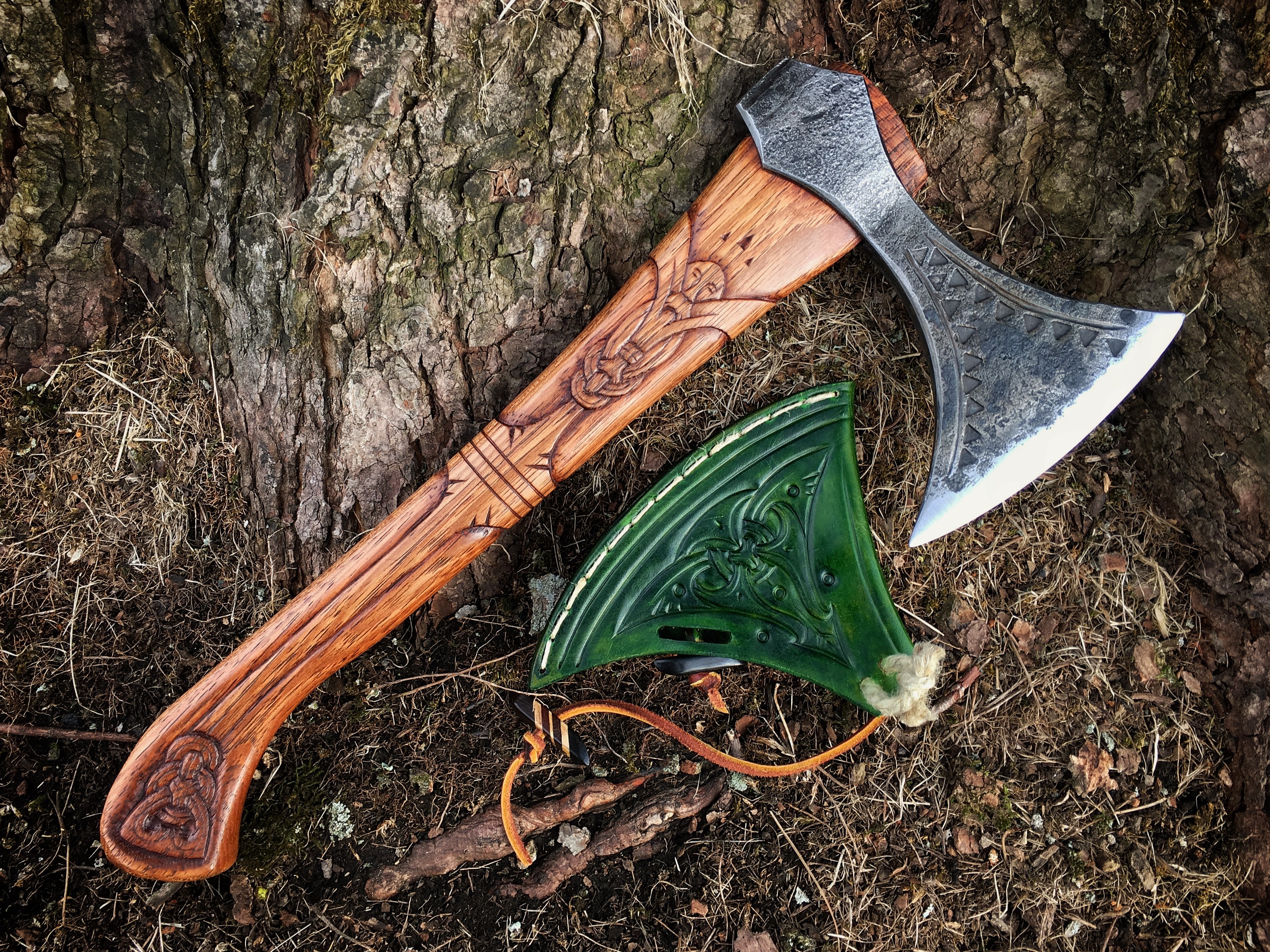 Battle axe with carved wooden handle and green sheath HD Wallpaper