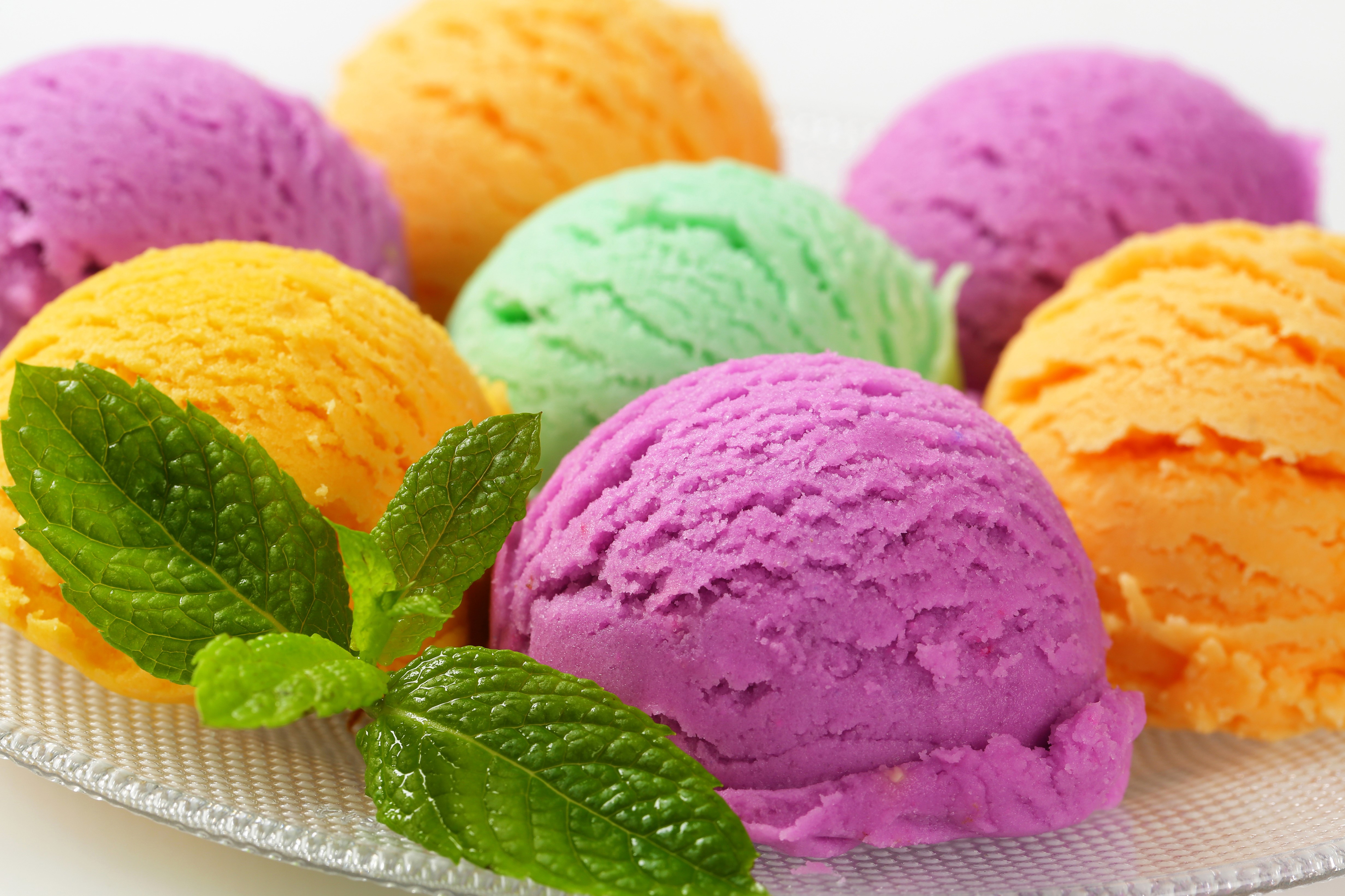 Assortment of colorful ice cream scoops with mint leaves HD Wallpaper