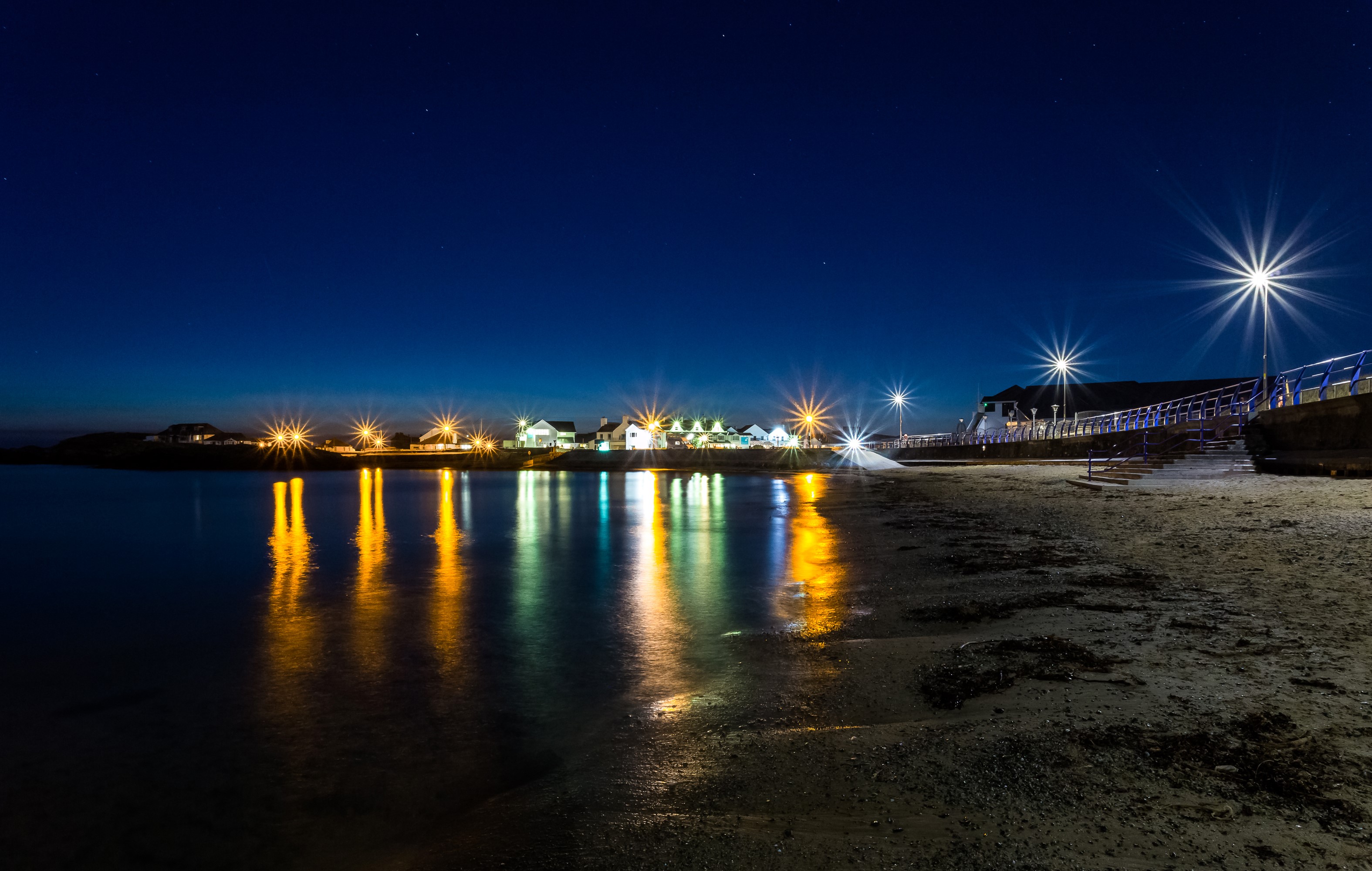 Trearddur Bay at night with reflections HD Wallpaper