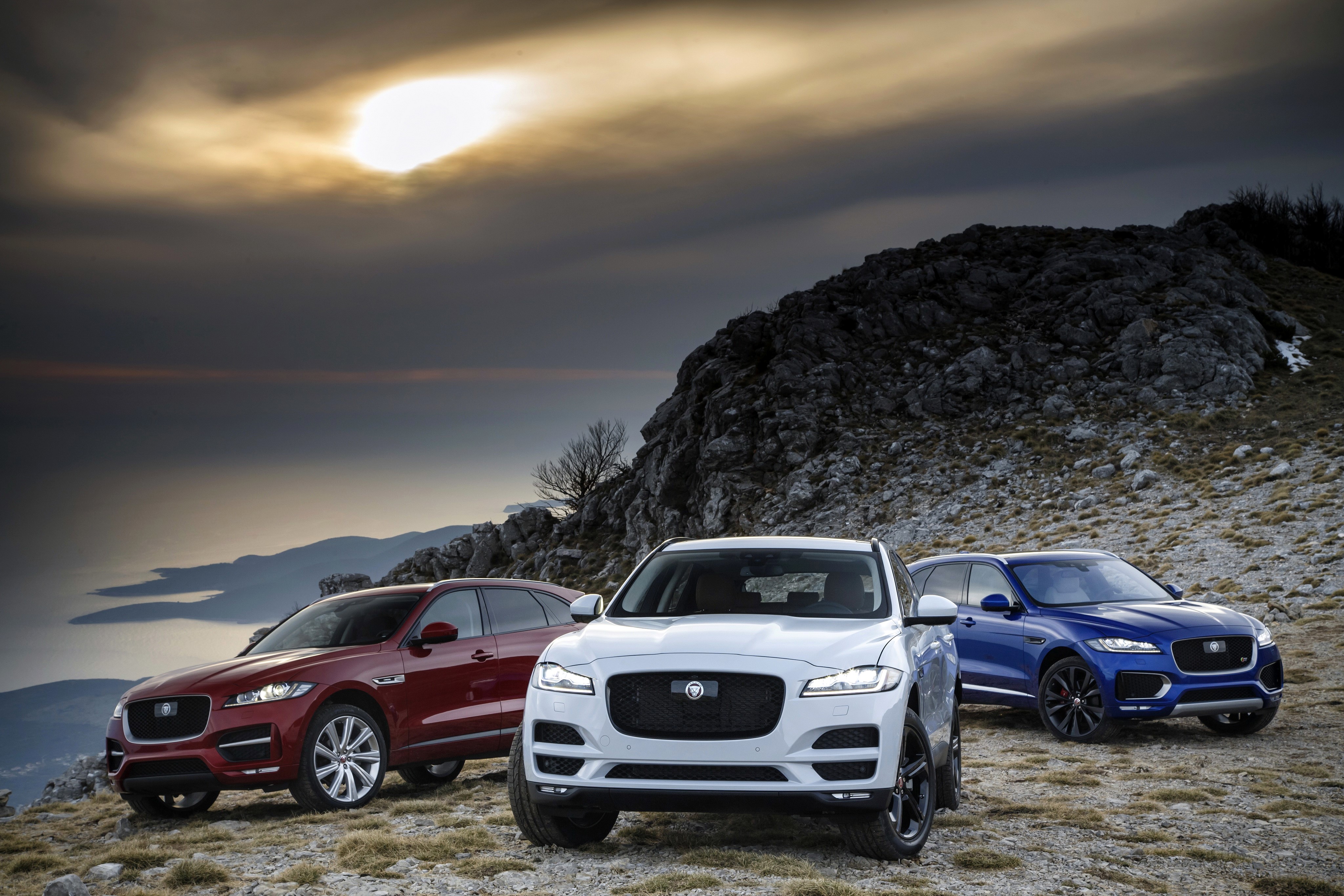 Three Jaguar F-Pace cars on a rocky mountain HD Wallpaper