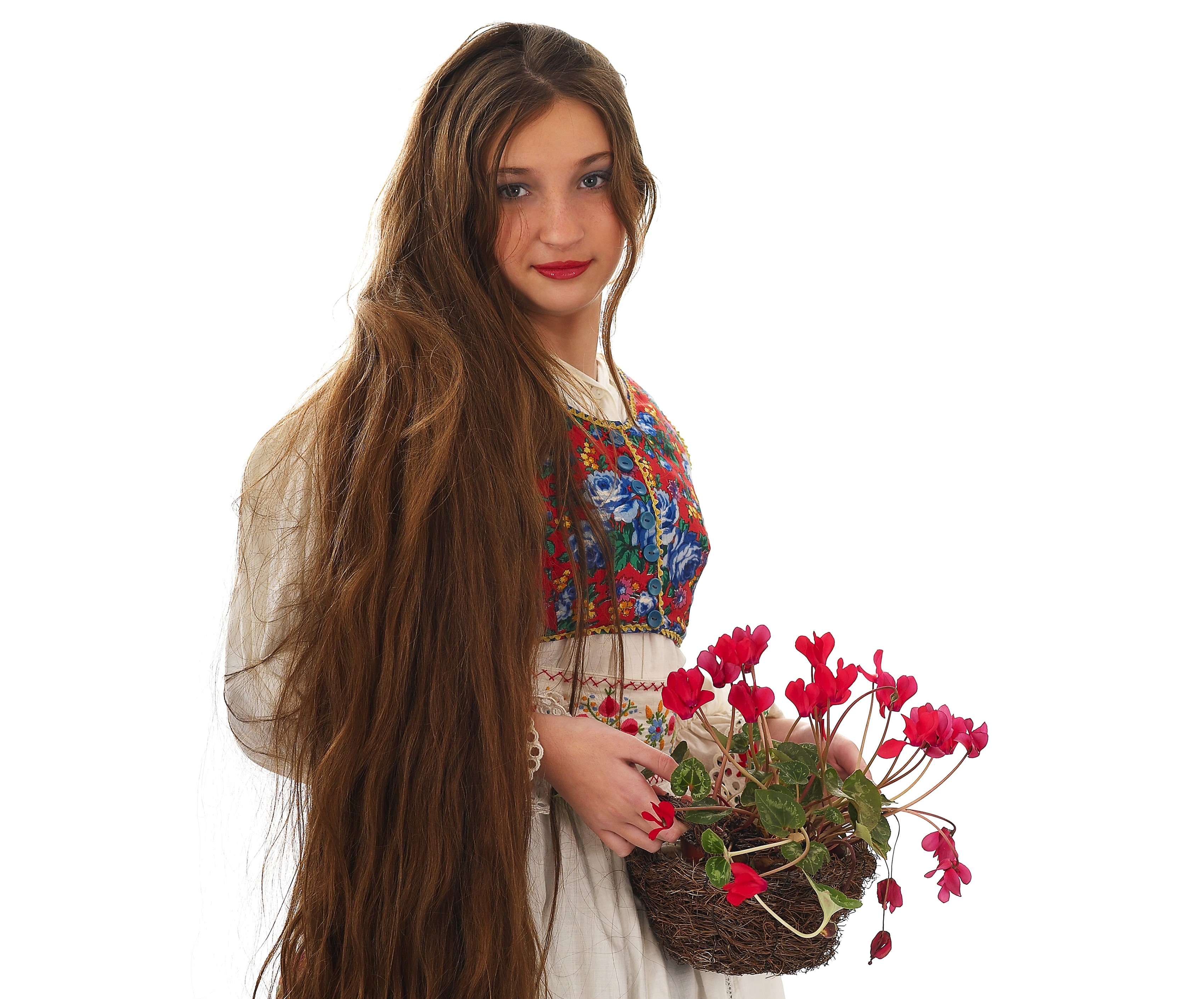 Young woman with long brown hair holding flowers HD Wallpaper