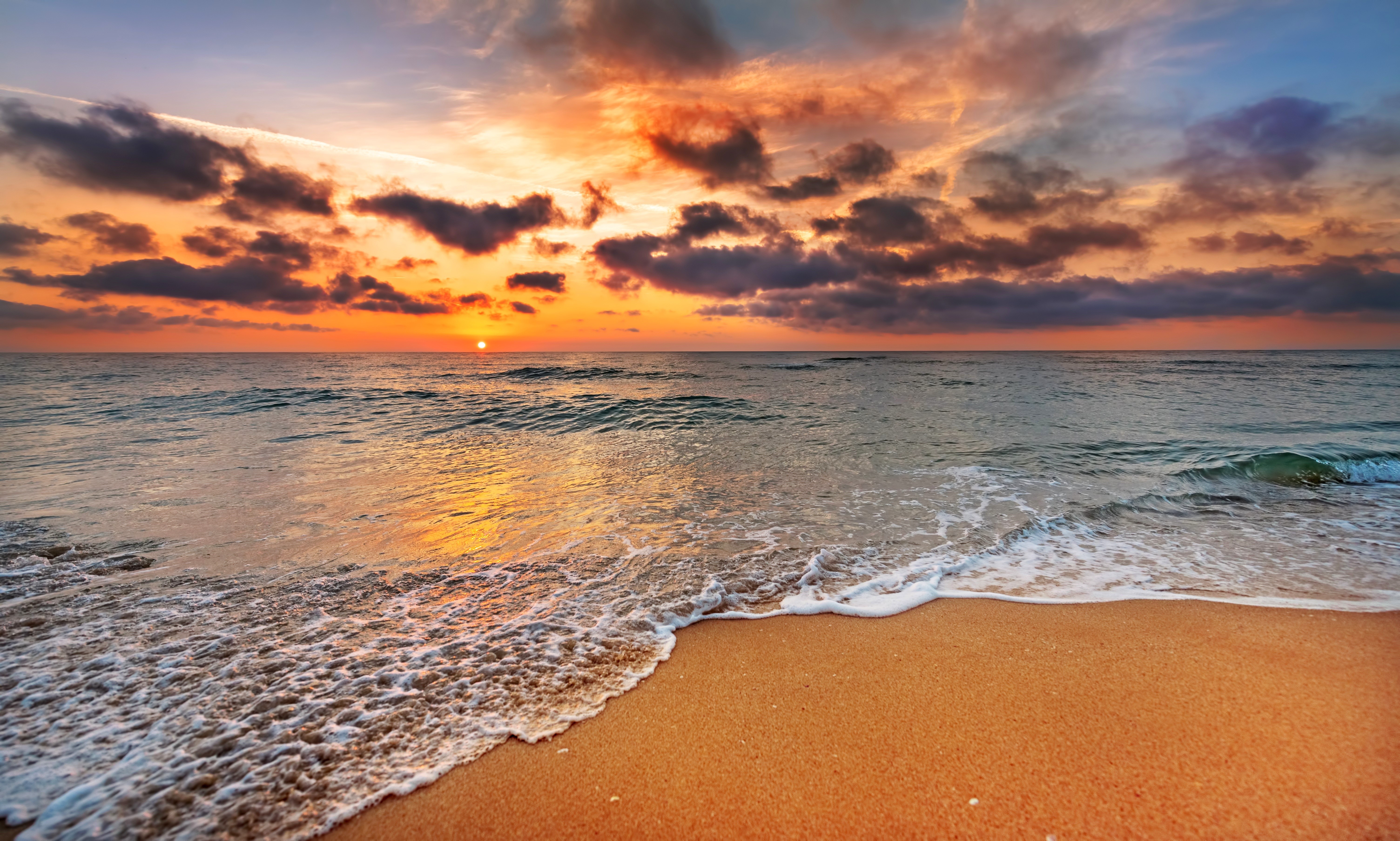 Sunset over the ocean with clouds and beach HD Wallpaper