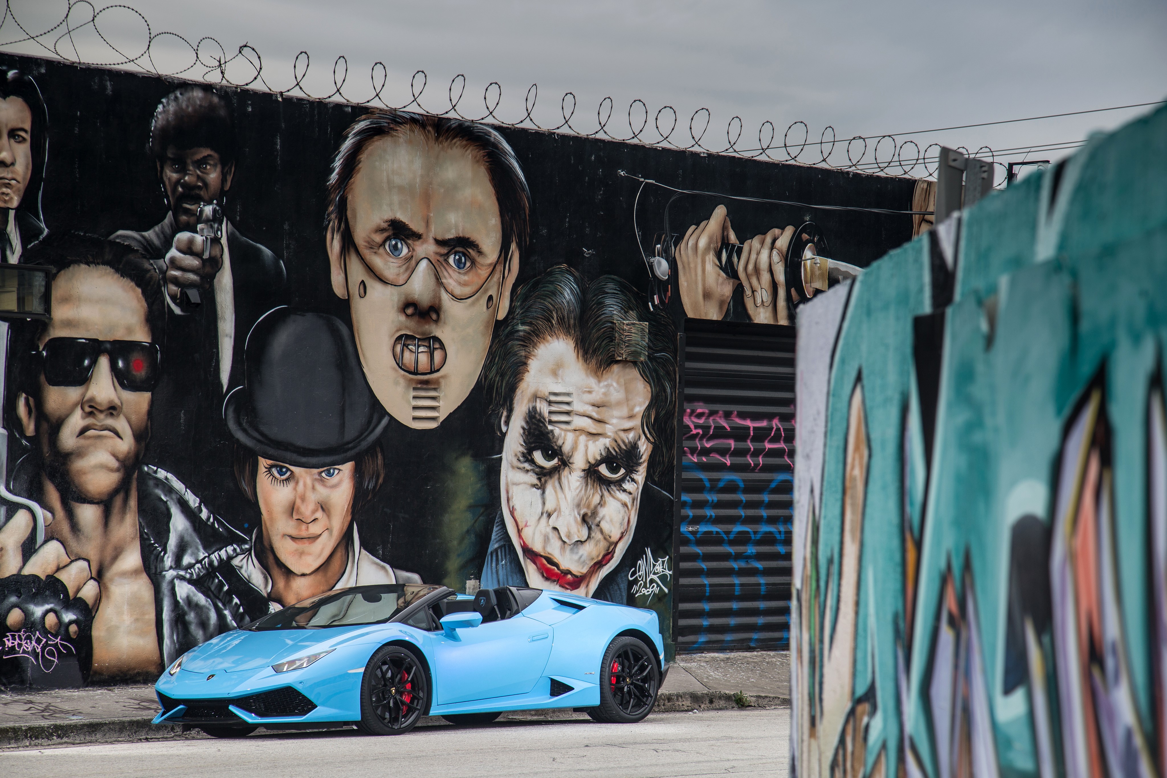 Light Blue Lamborghini Cabriolet in front of Movie Character Graffiti HD Wallpaper