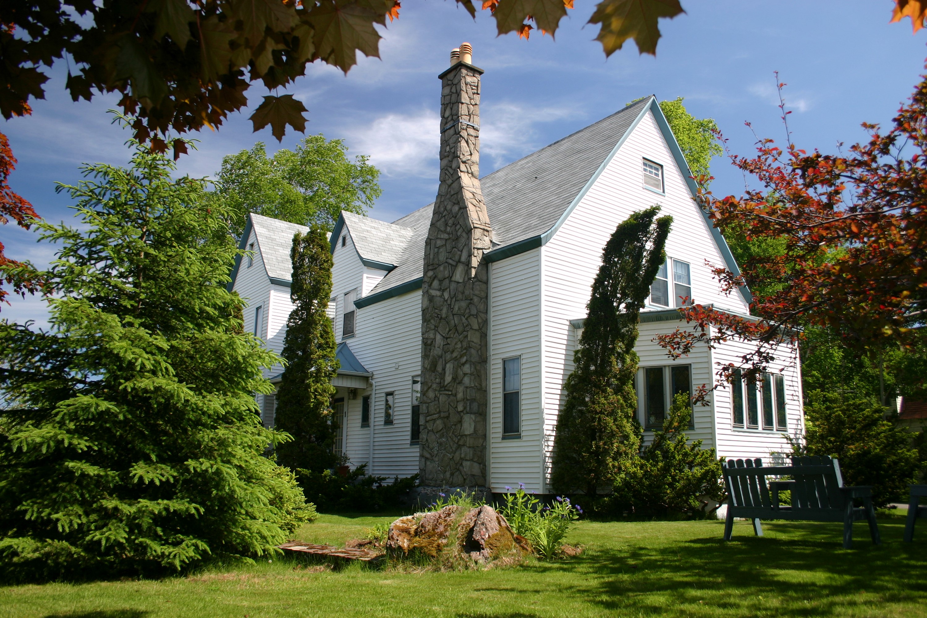 White house with stone chimney and trees HD Wallpaper