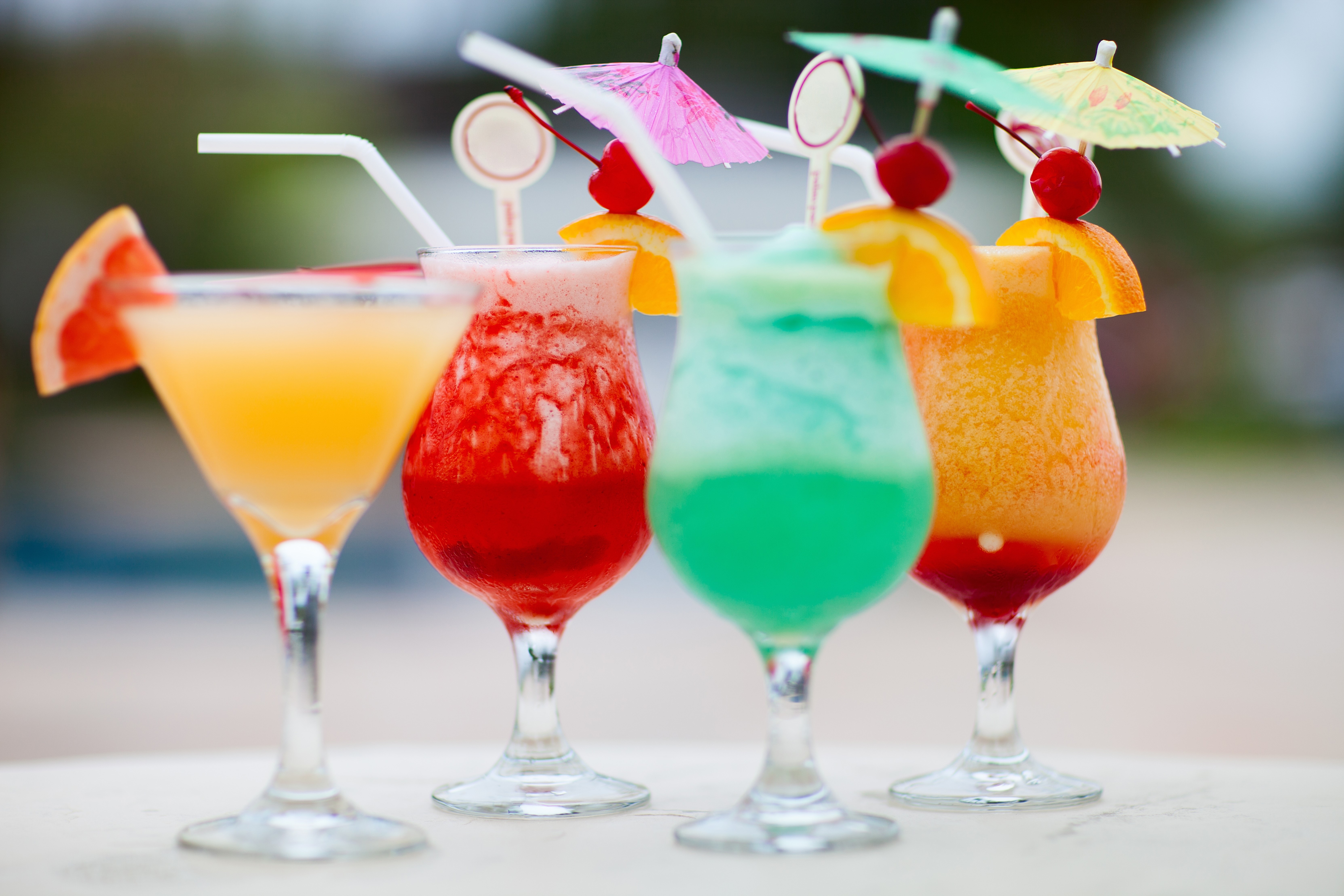 Four colorful cocktails with garnishes HD Wallpaper