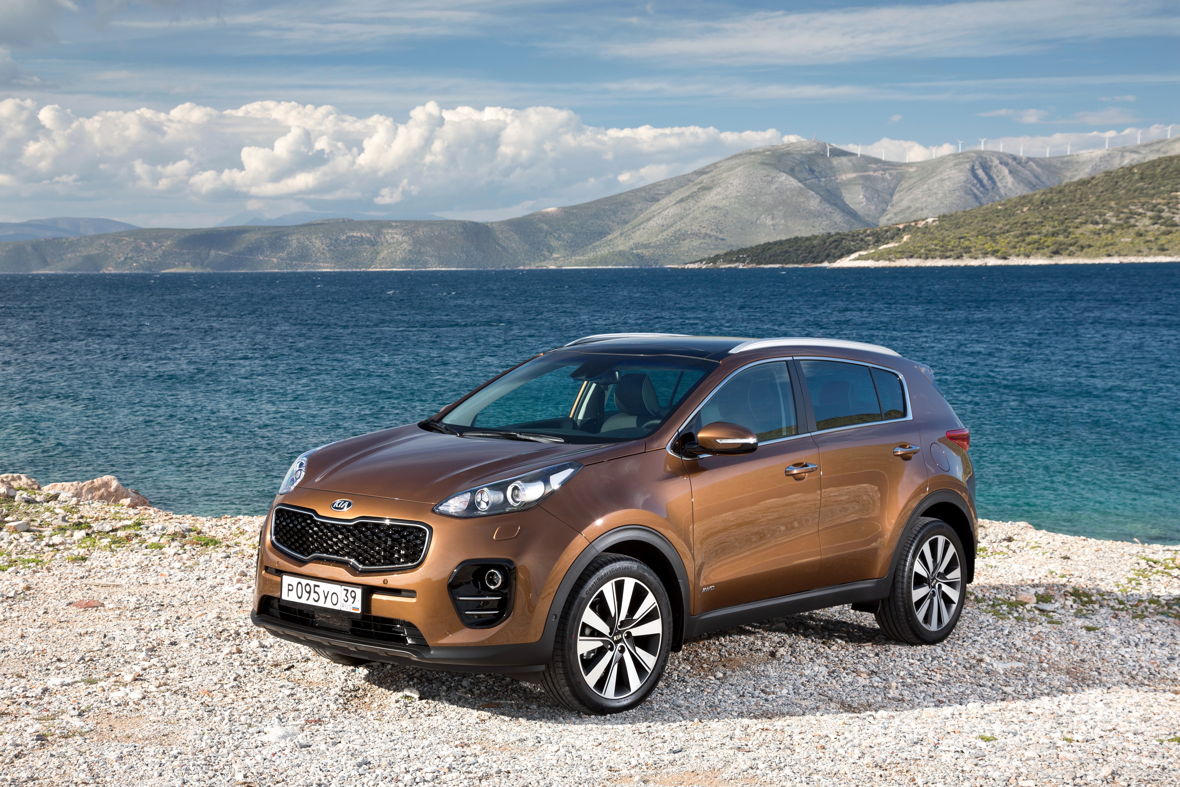 2015 Kia Sportage QL on a rocky coast HD Wallpaper