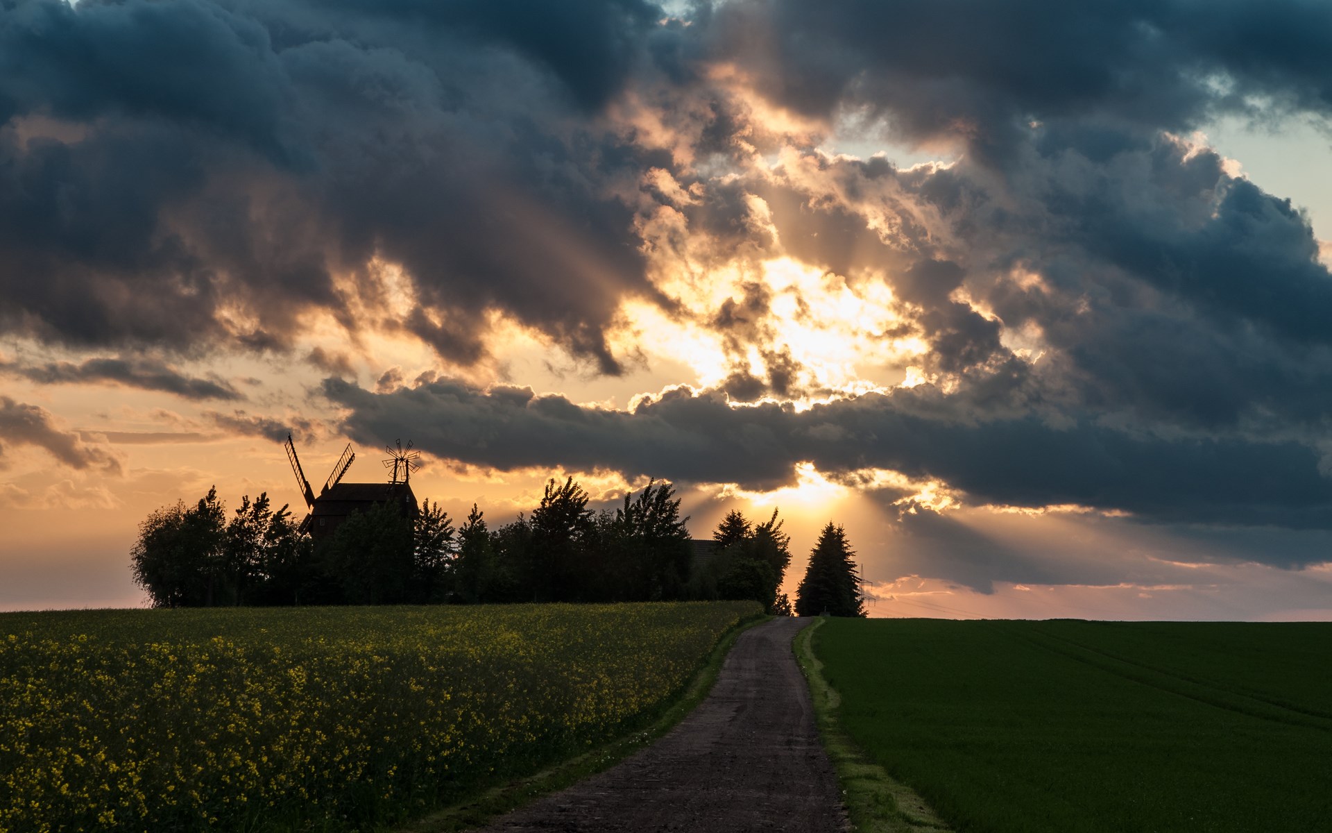 Sunset over a rural landscape with a windmill HD Wallpaper