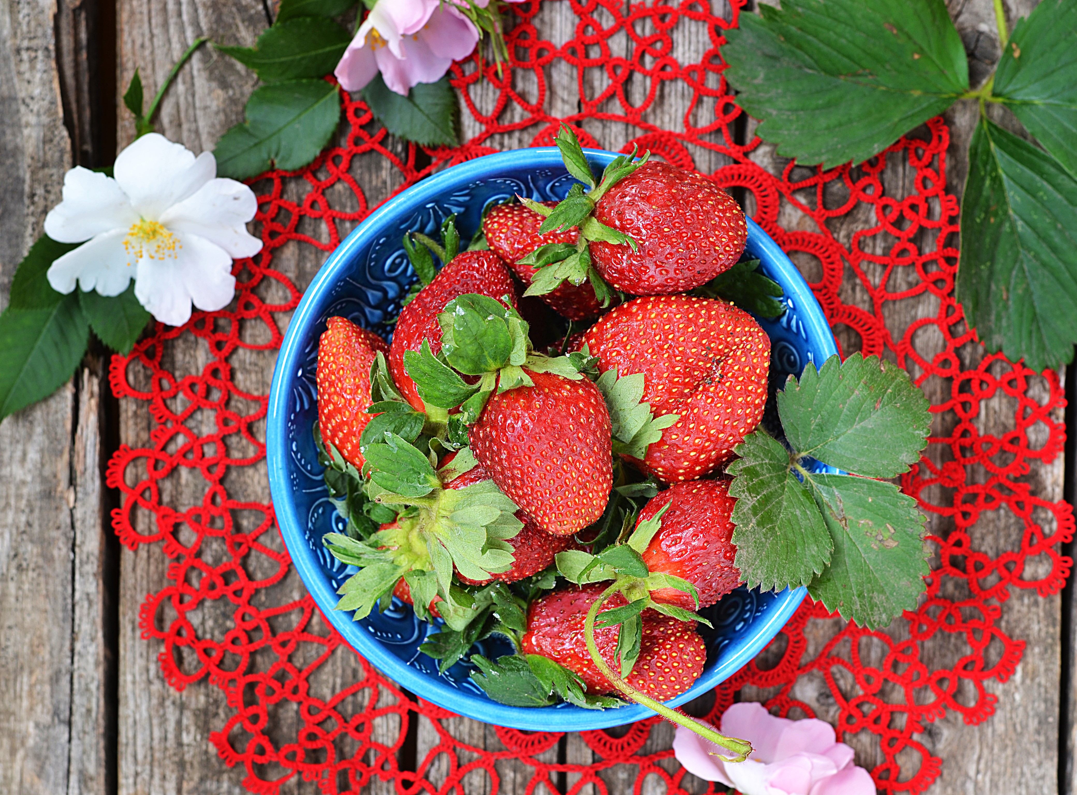 Strawberries in a blue bowl on a wooden table HD Wallpaper