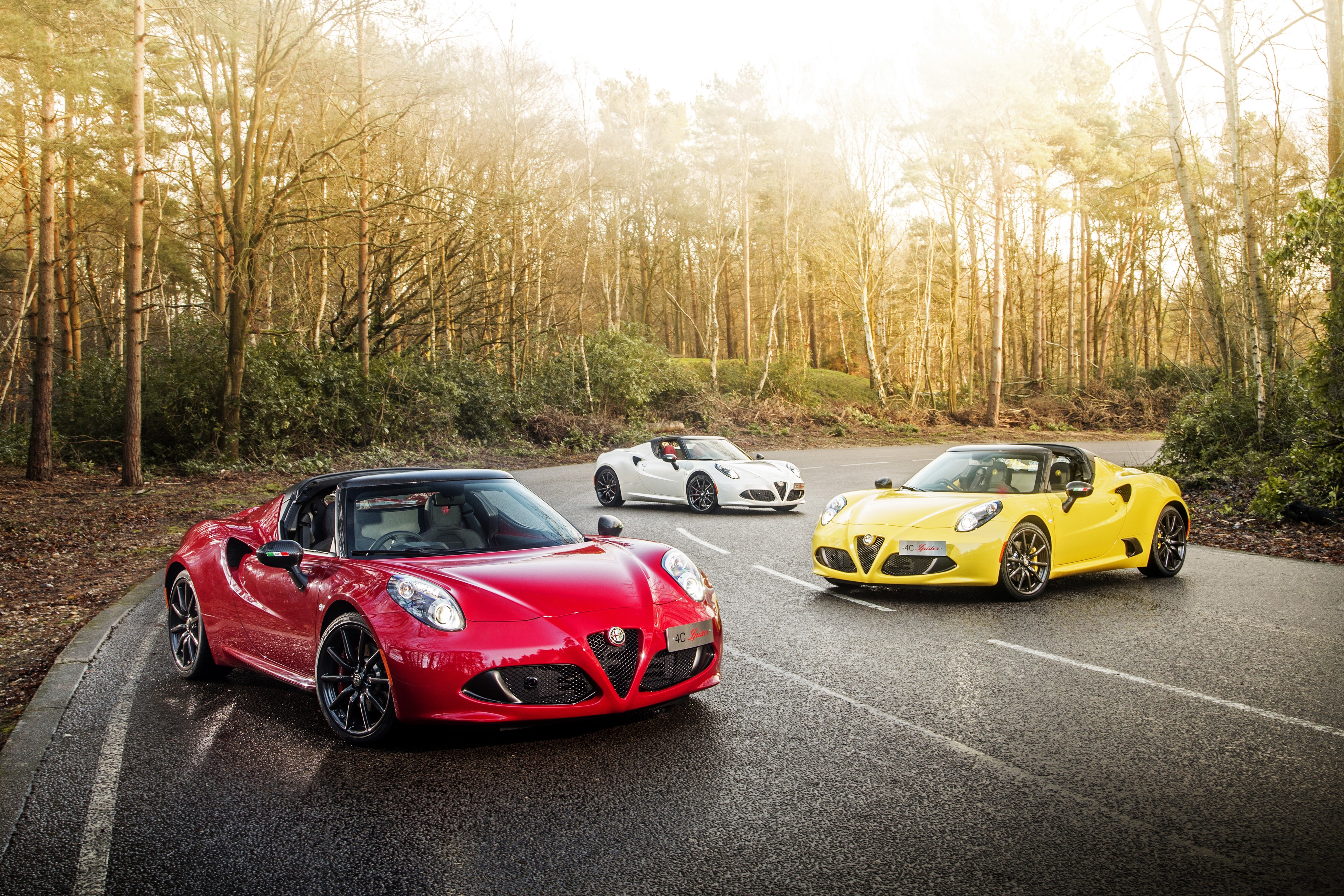 Three Alfa Romeo 4C Spider cars on a road HD Wallpaper