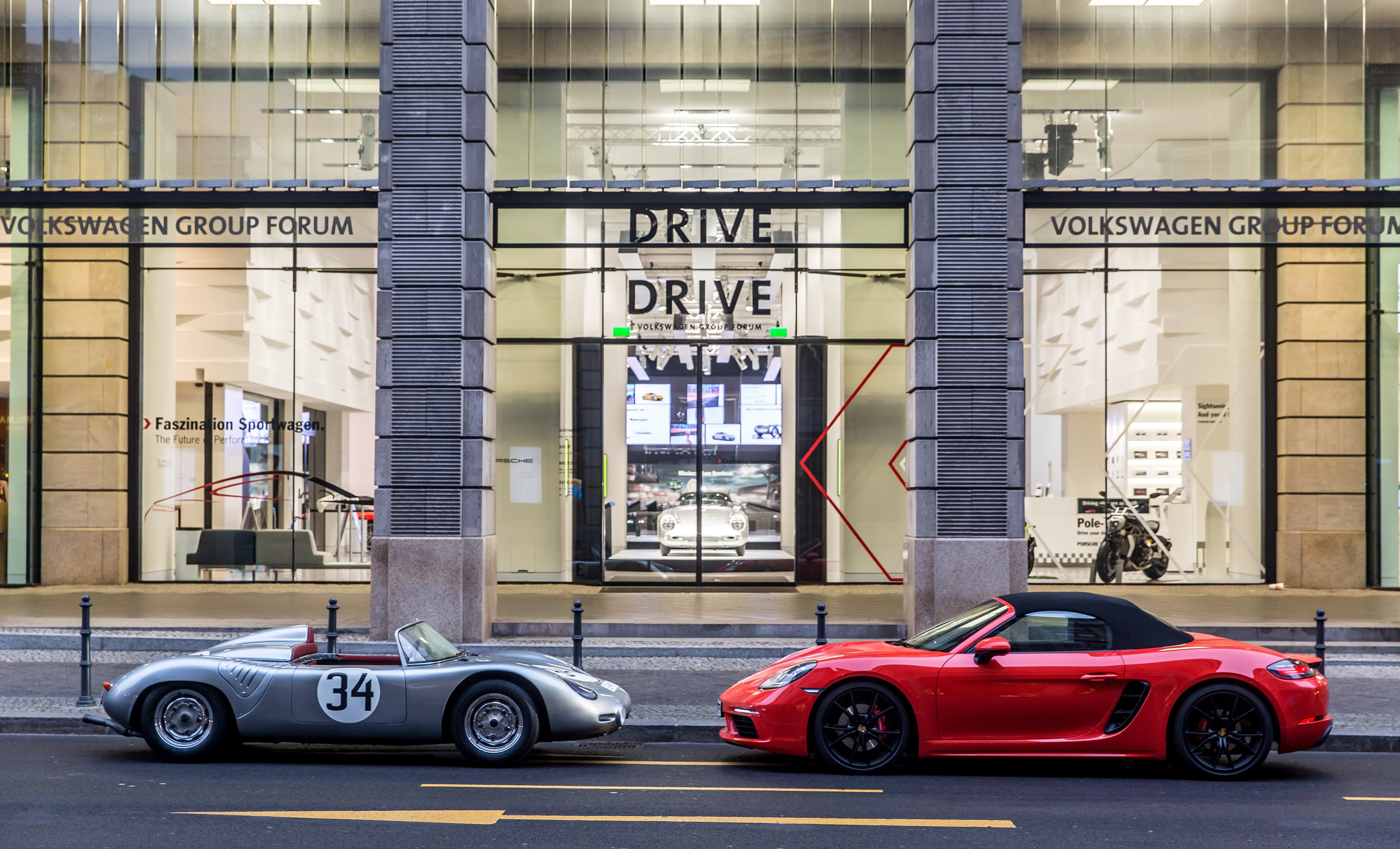 Two Porsche convertibles in front of Volkswagen Group Forum HD Wallpaper