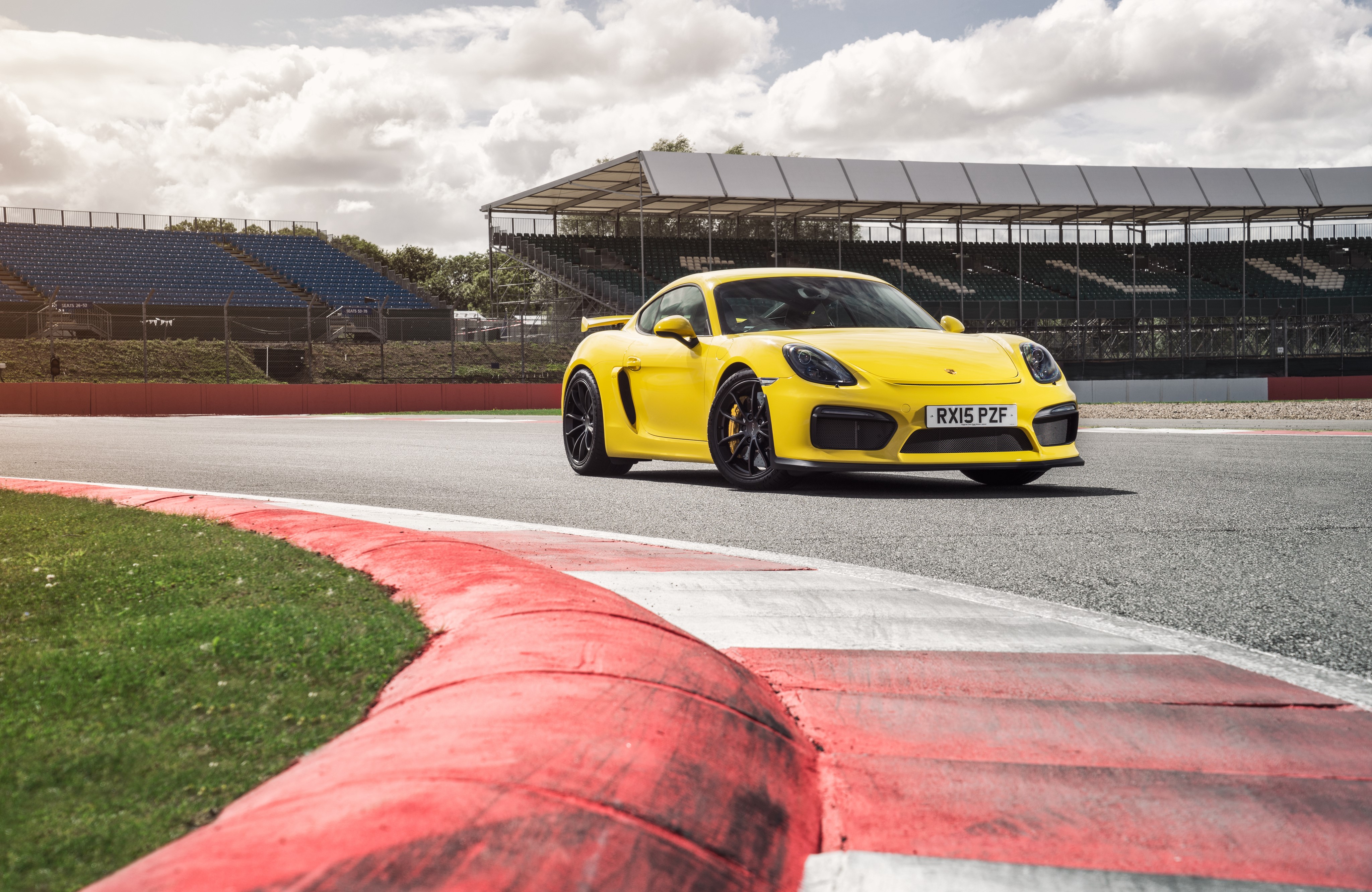 Yellow Porsche Cayman GT4 on a Race Track HD Wallpaper