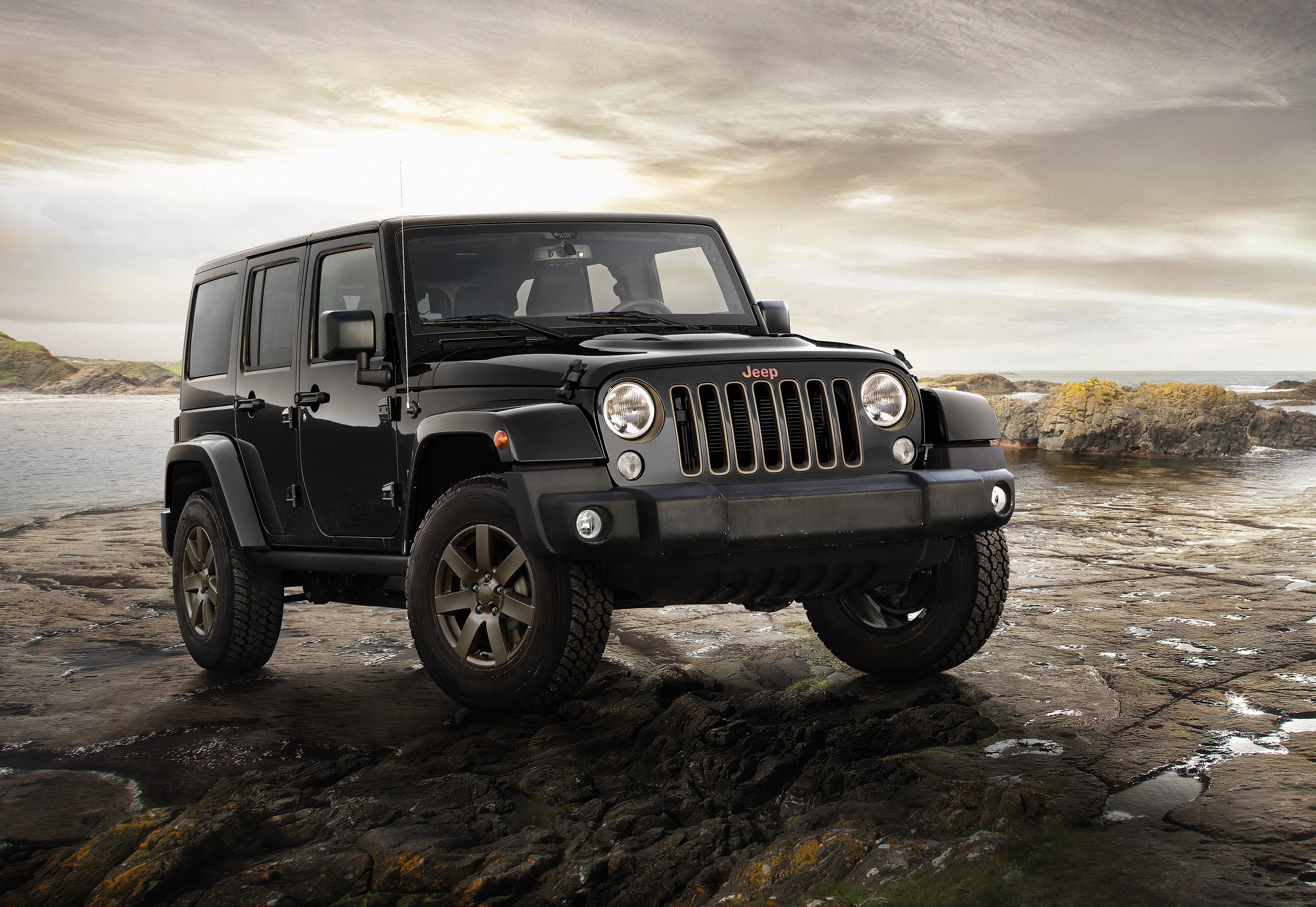 Black Jeep Wrangler on rocky shore HD Wallpaper