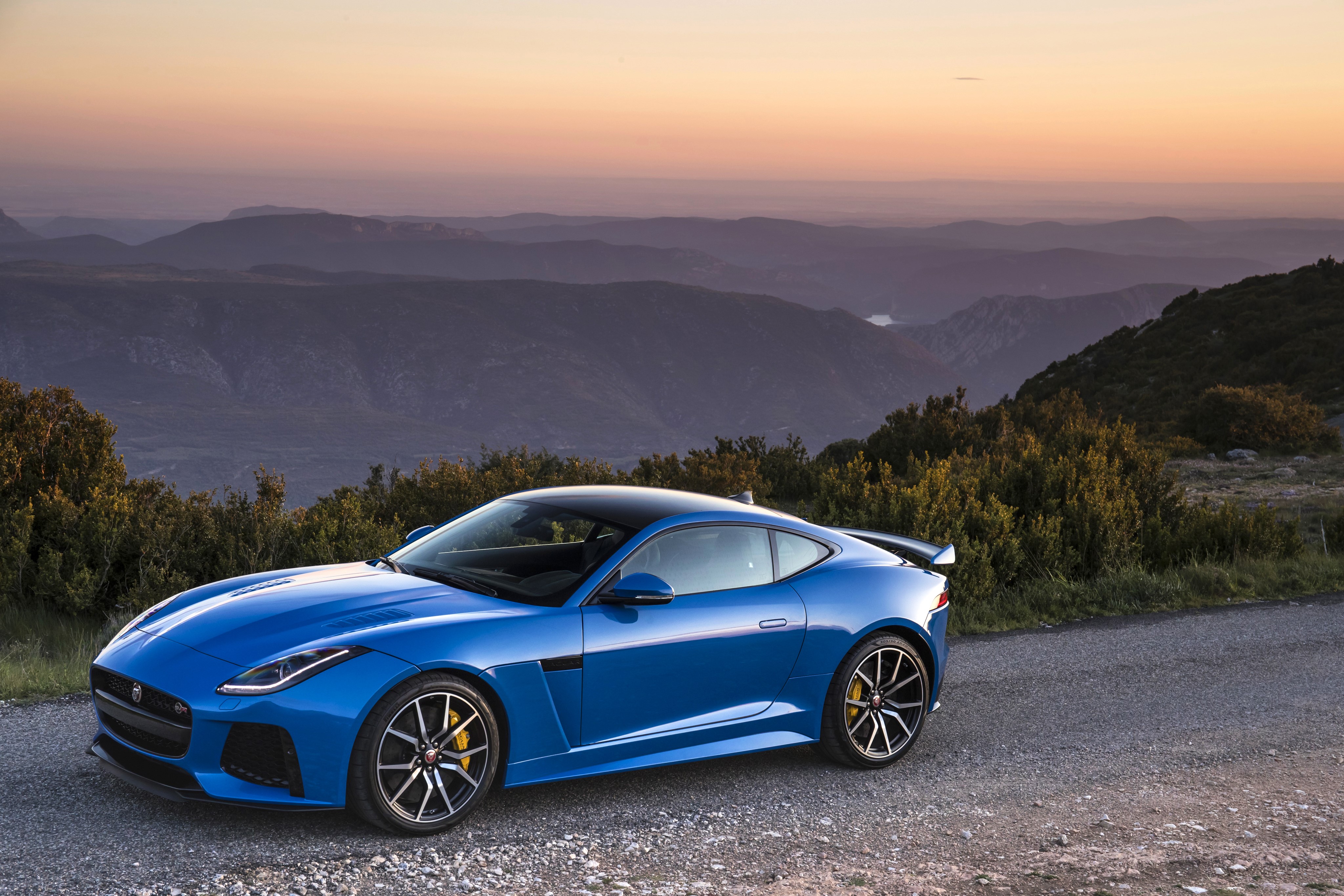 Blue Jaguar F-Type Coupe on Mountain Road at Sunset HD Wallpaper