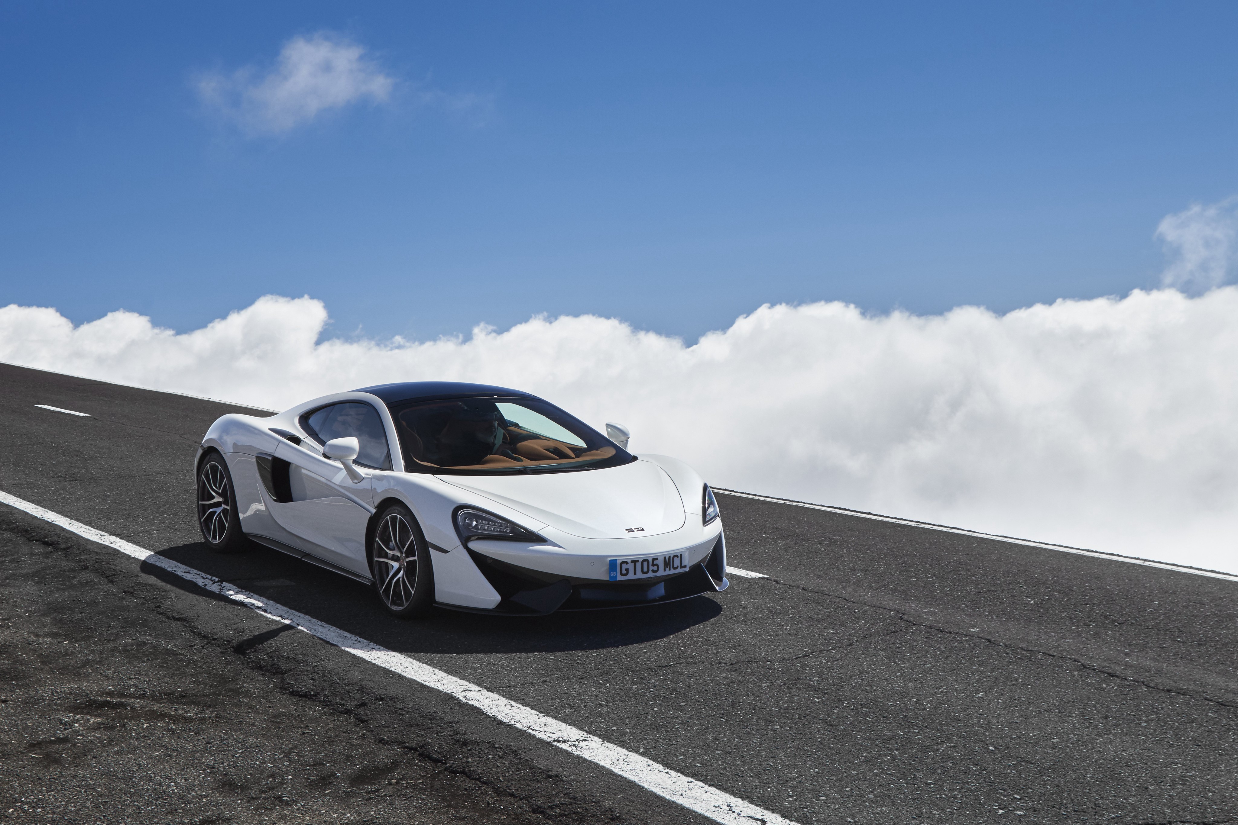 White McLaren 570GT on a Mountain Road HD Wallpaper