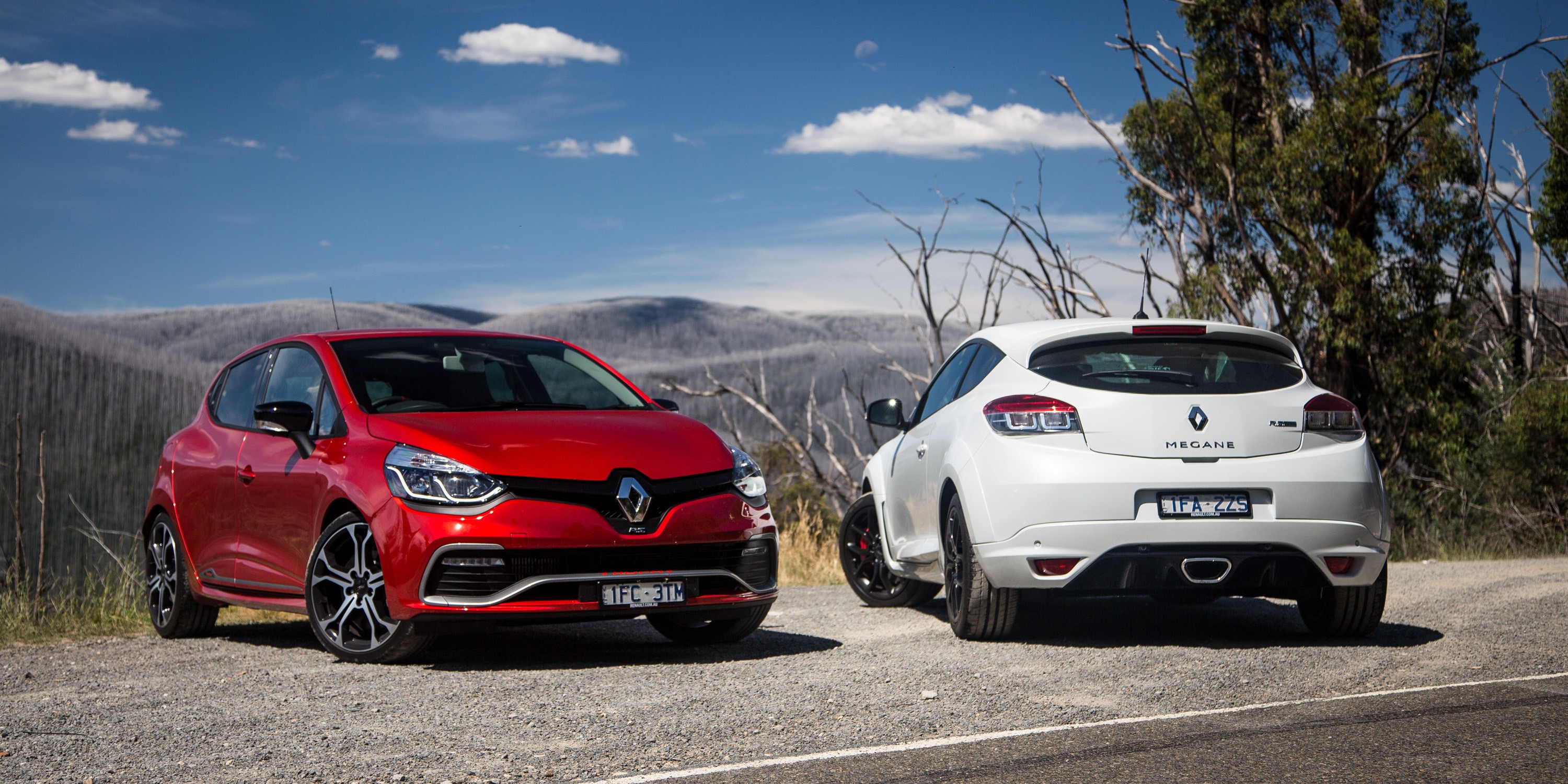 Two Renault cars, a red Clio RS and a white Megane HD Wallpaper