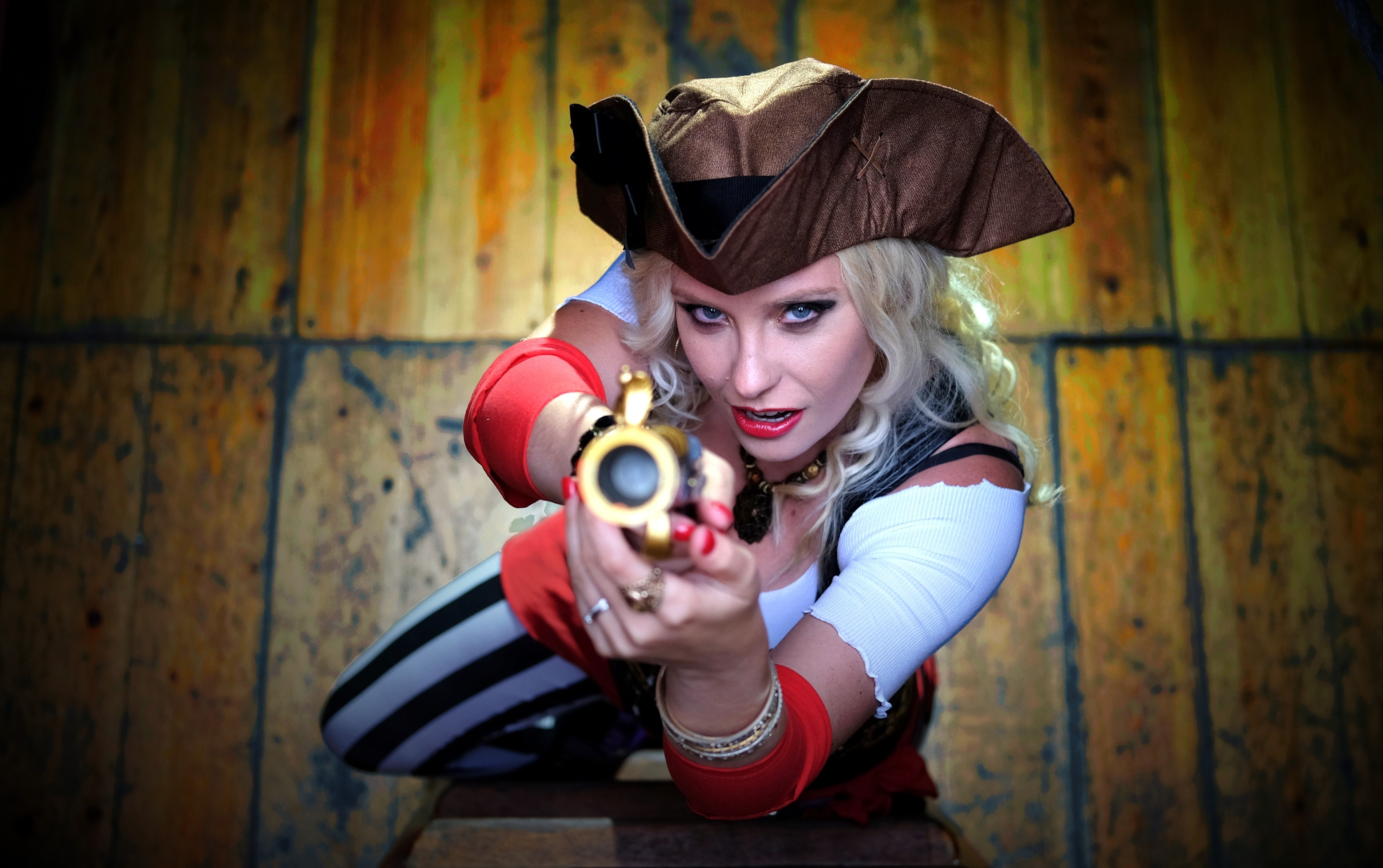 Woman in pirate costume aiming a pistol HD Wallpaper