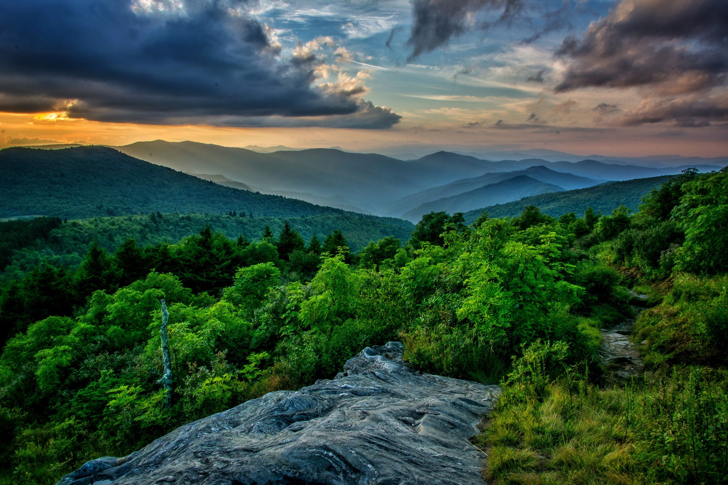 Mountain range at sunset with dramatic clouds HD Wallpaper