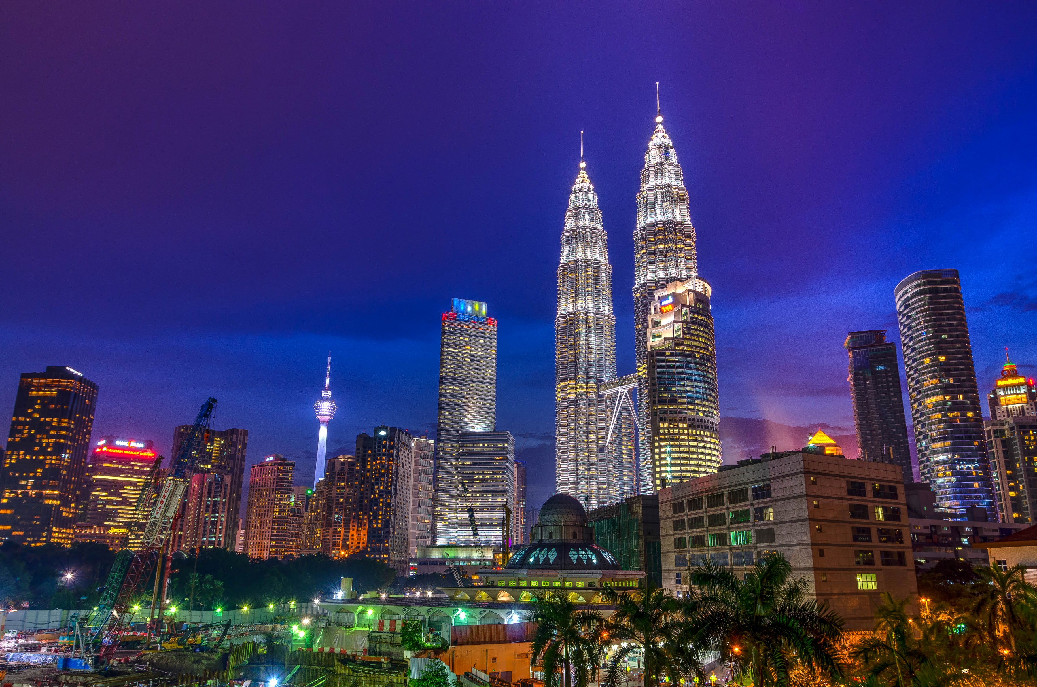 Petronas Towers and Kuala Lumpur skyline at night HD Wallpaper