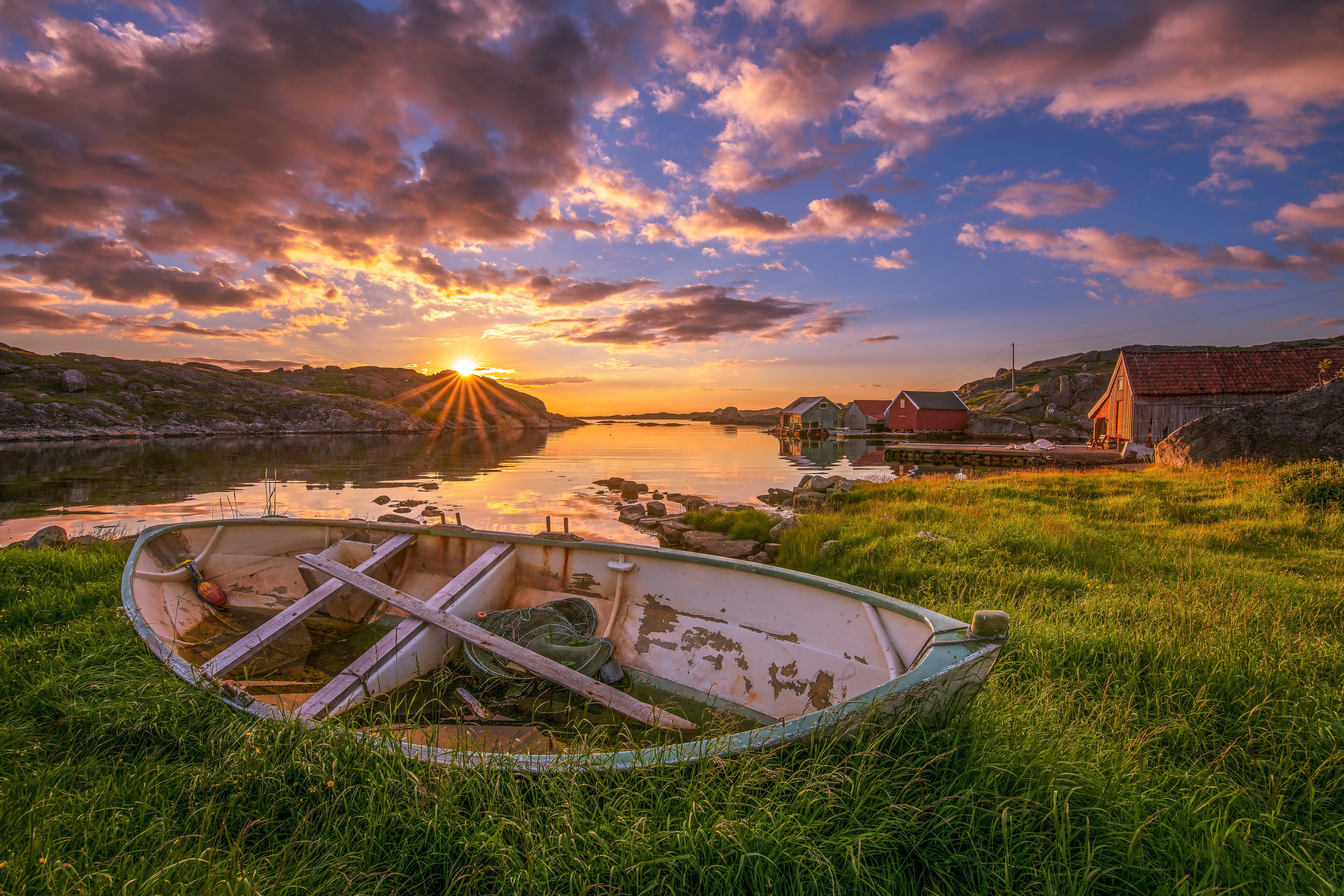 Sunset over Norwegian coast with boat and cabins HD Wallpaper