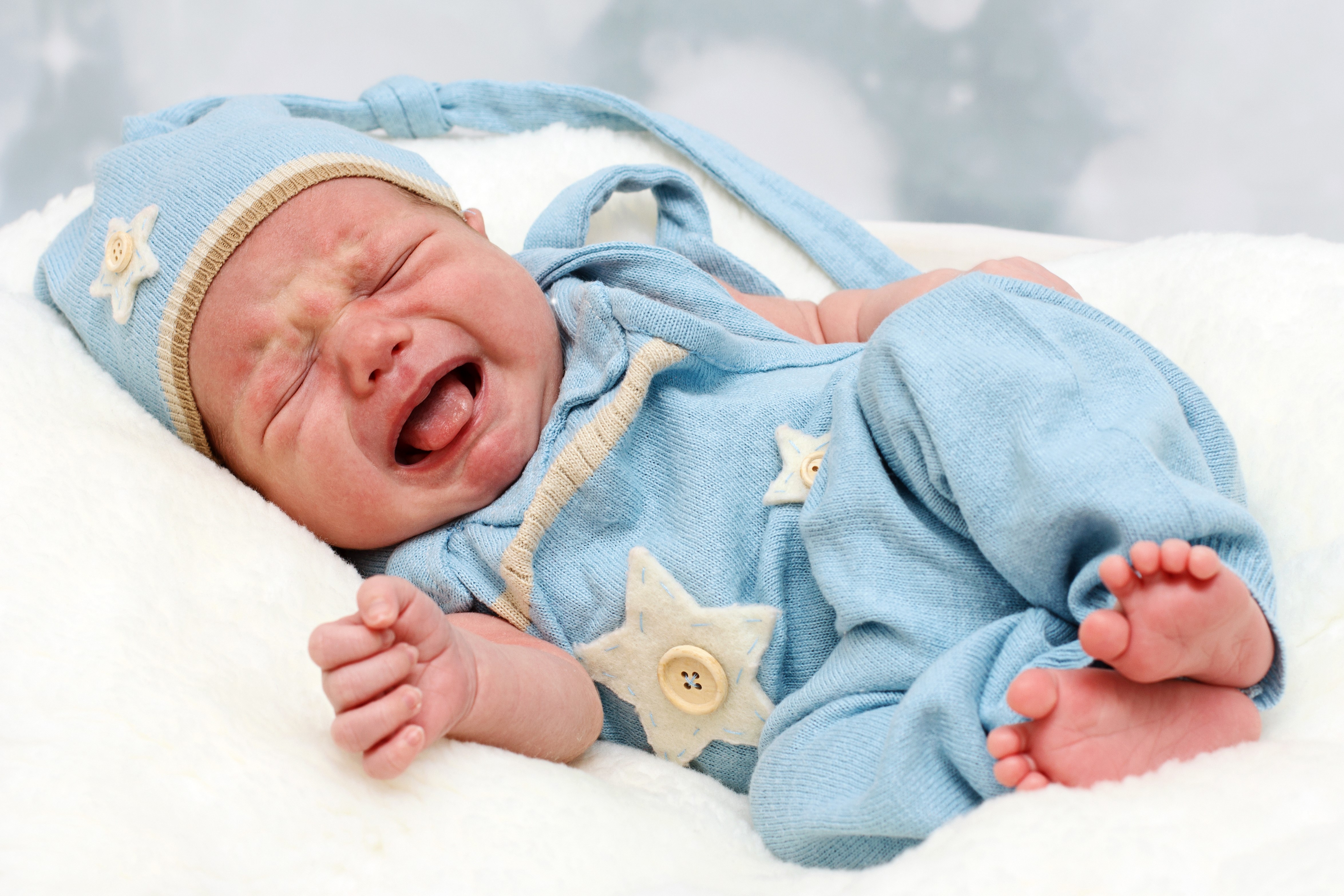 Crying baby in blue winter hat and outfit HD Wallpaper