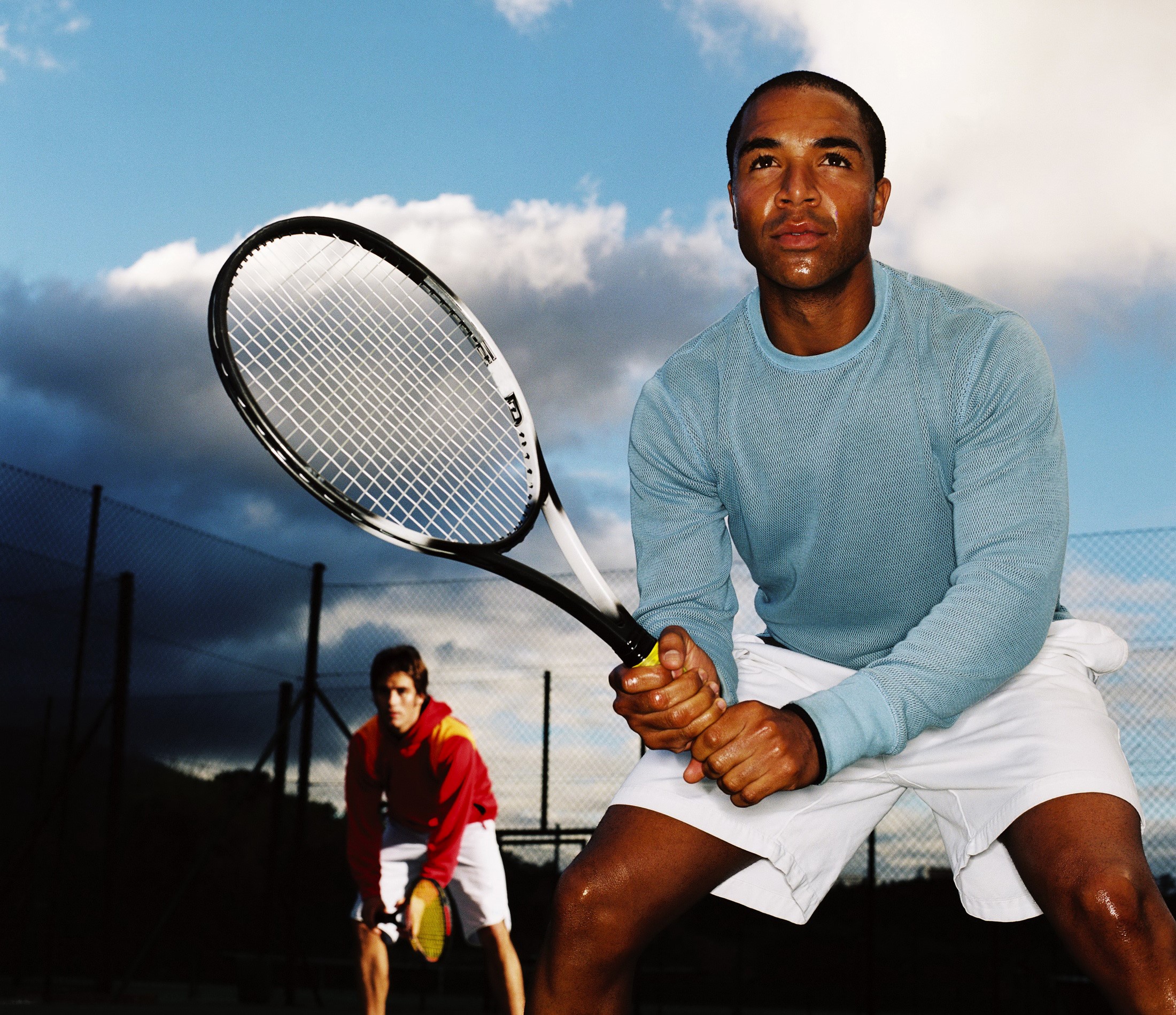Two men playing tennis on a court HD Wallpaper