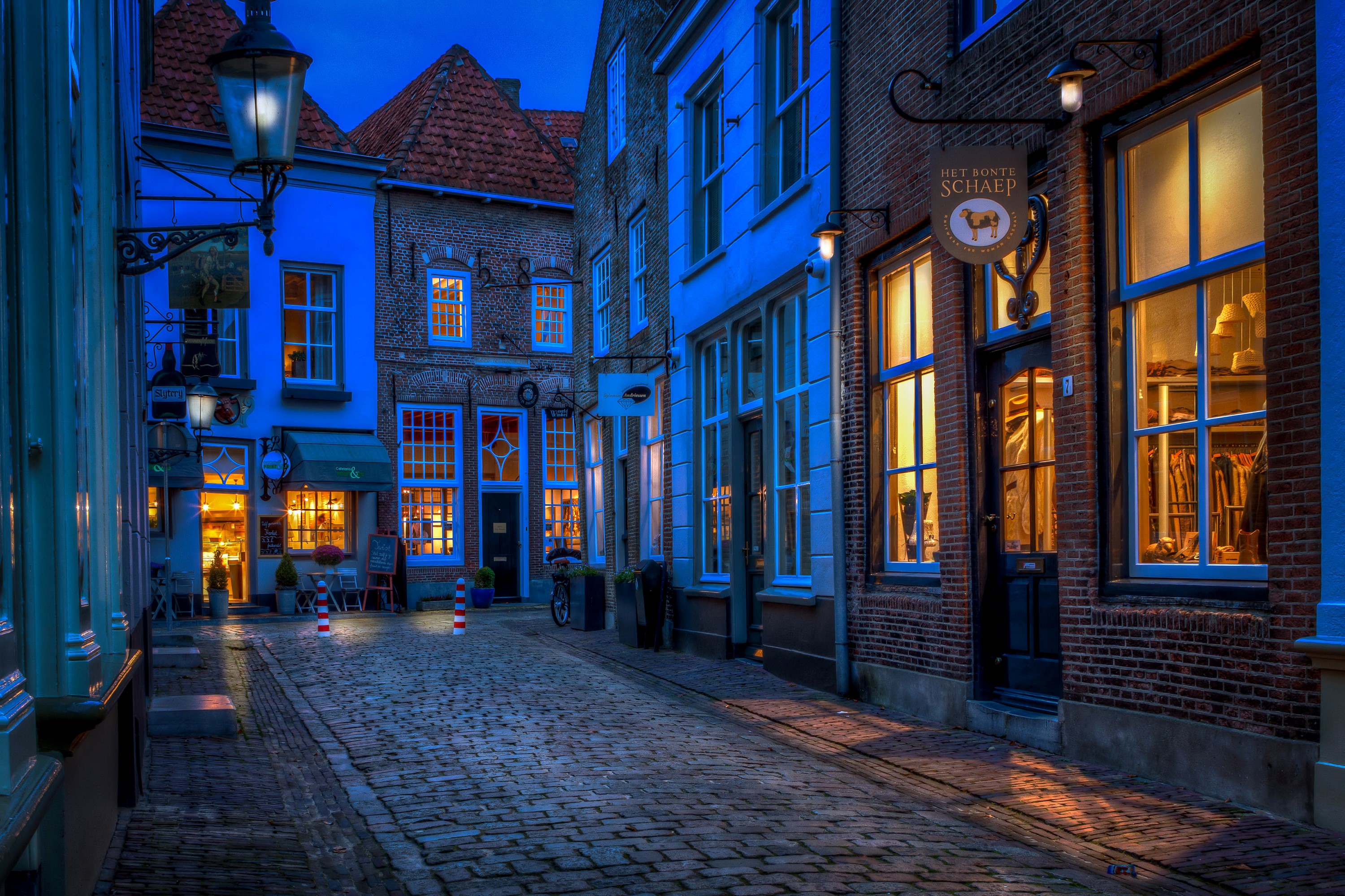 Street in Heusden, Netherlands at dusk with street lights HD Wallpaper