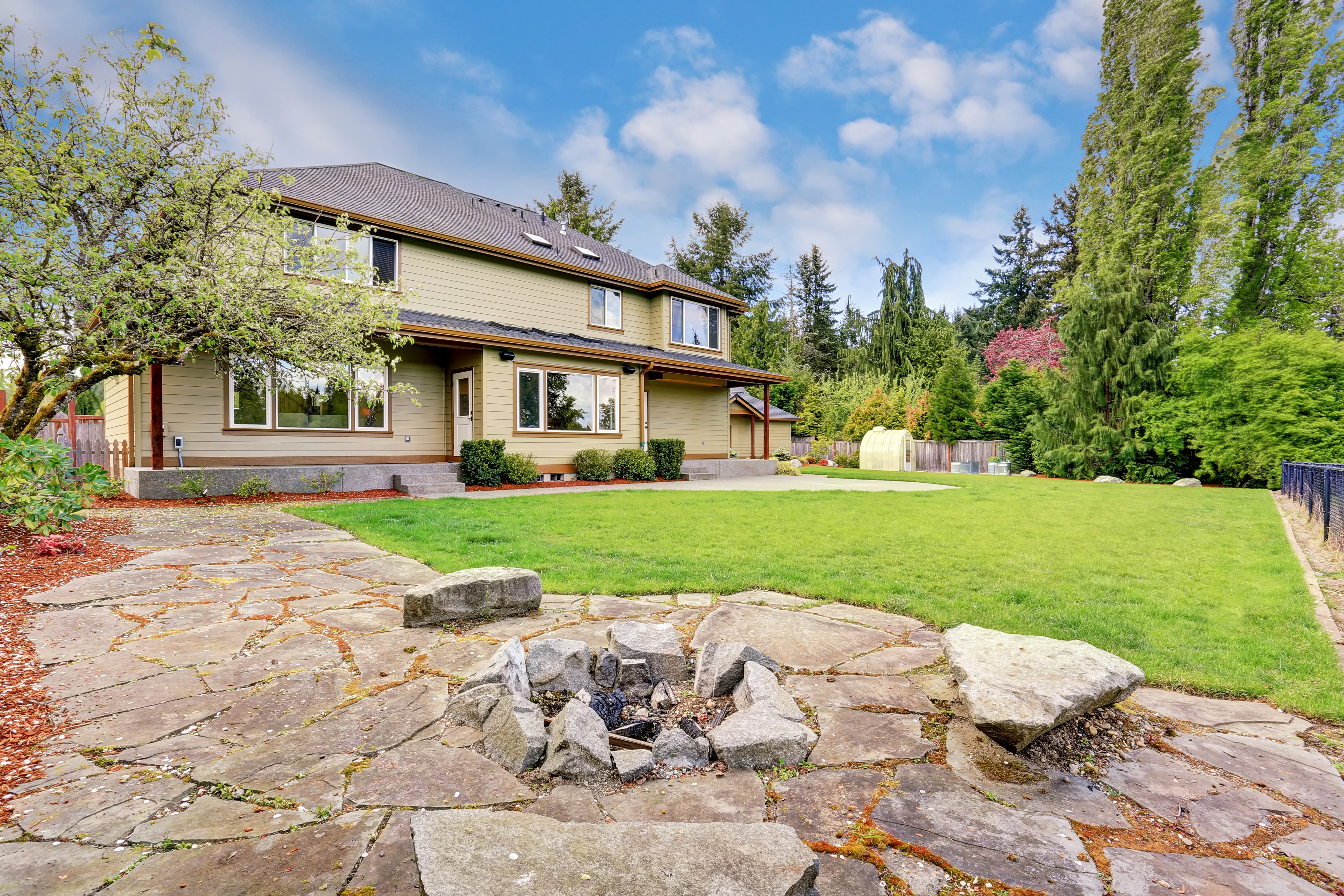 House with stone patio and fire pit HD Wallpaper