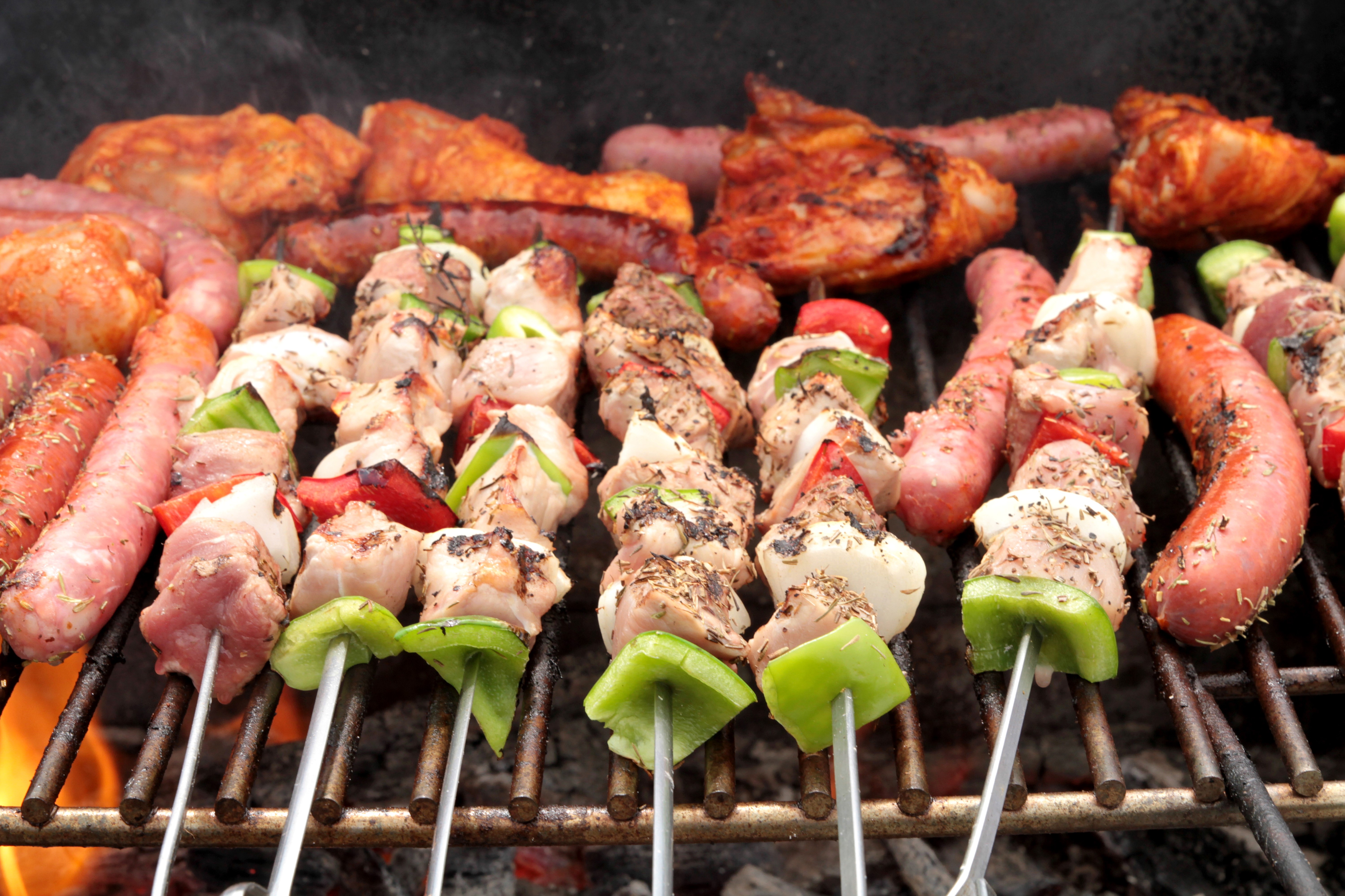 Meat products and sausages on a grill HD Wallpaper