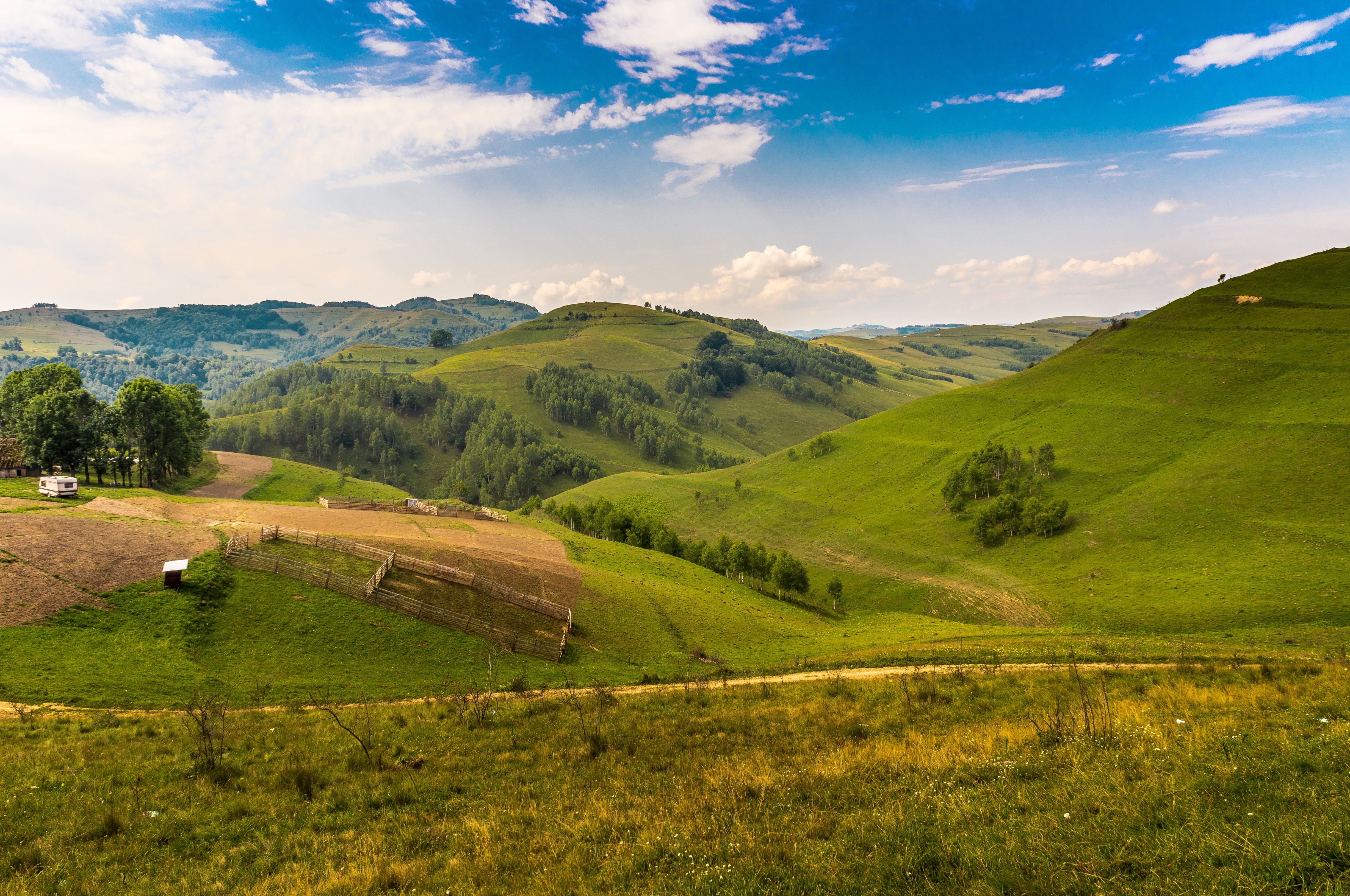 4K Romania Rolling Green Hills and Sky HD Wallpaper
