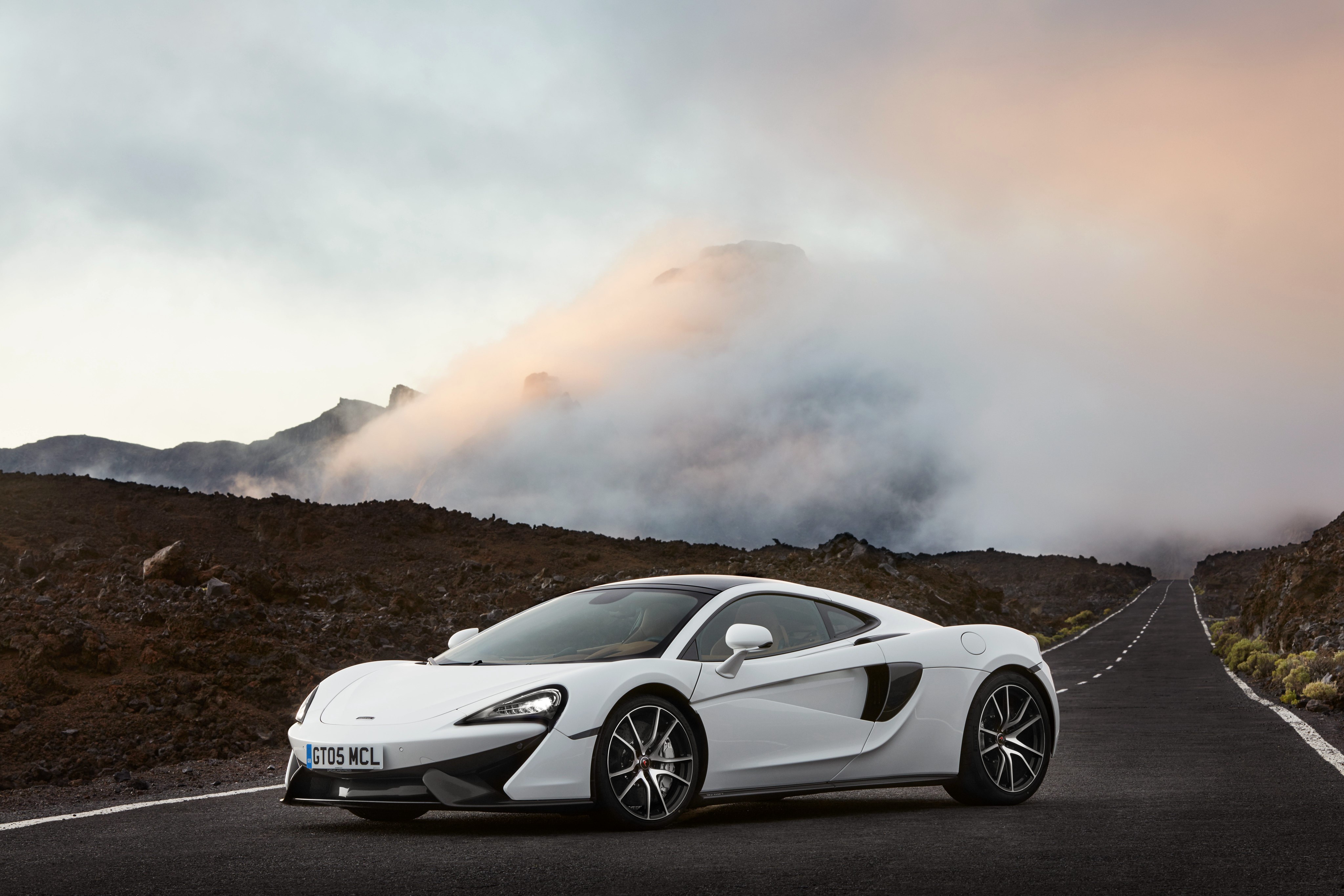 White McLaren 570GT on a Mountain Road HD Wallpaper