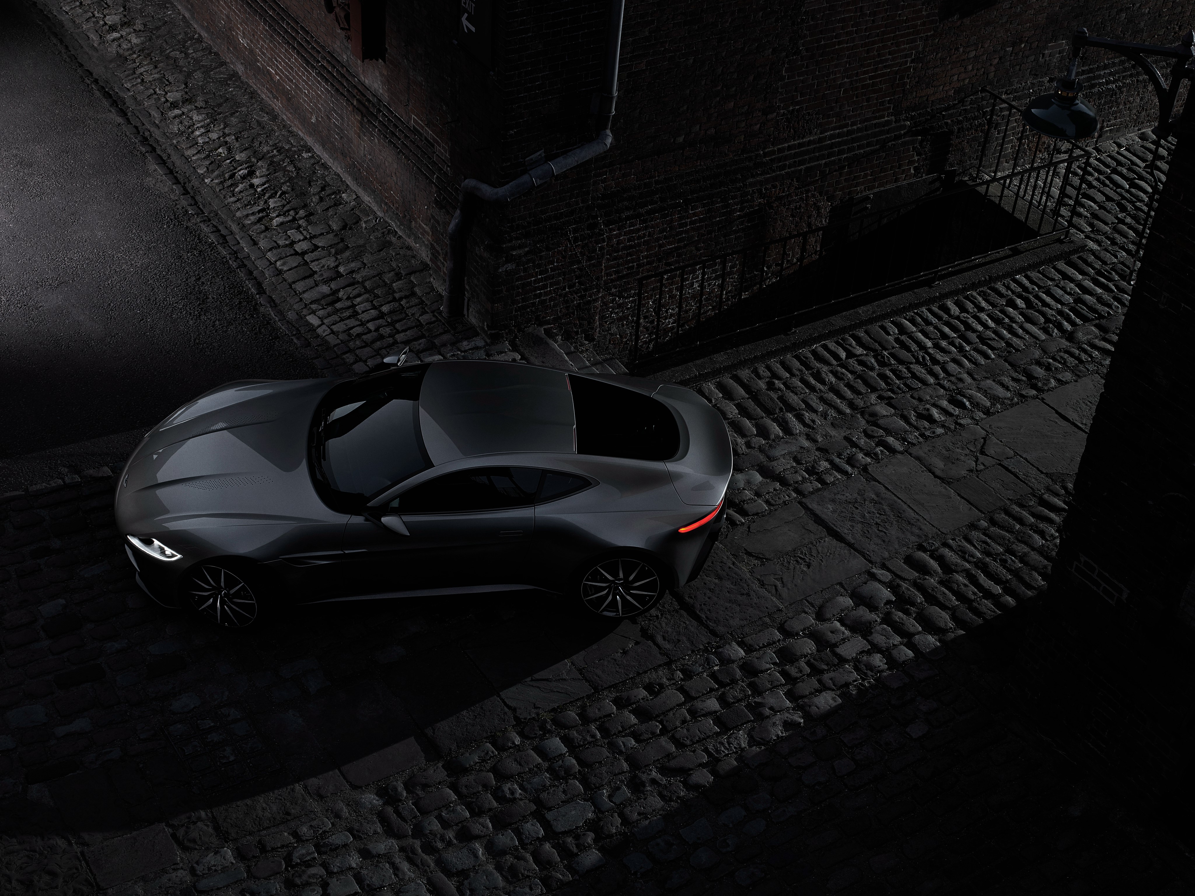 Aston Martin DB10 on cobblestone street HD Wallpaper