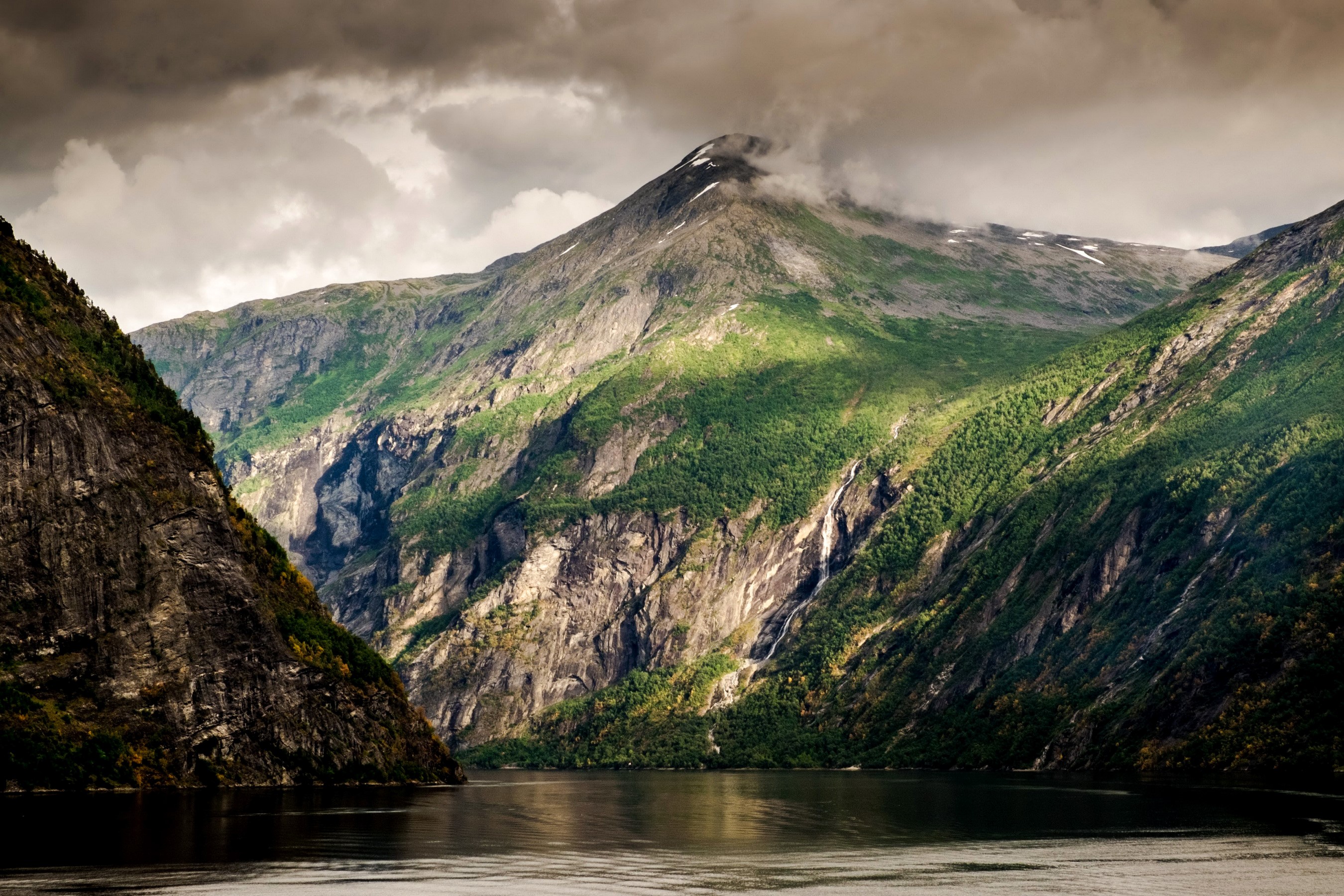 Mountains and a lake under a cloudy sky HD Wallpaper