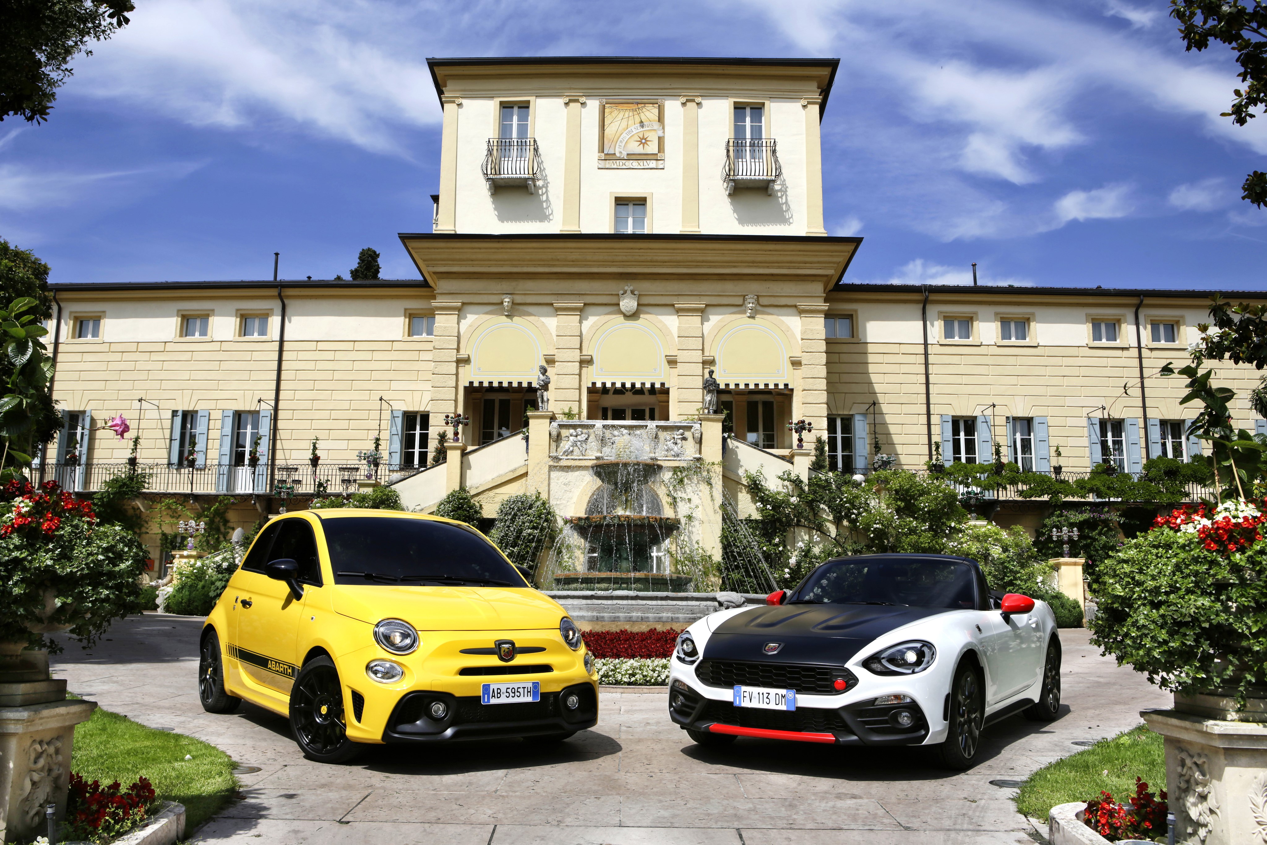 Two Abarth cars parked in front of a villa HD Wallpaper