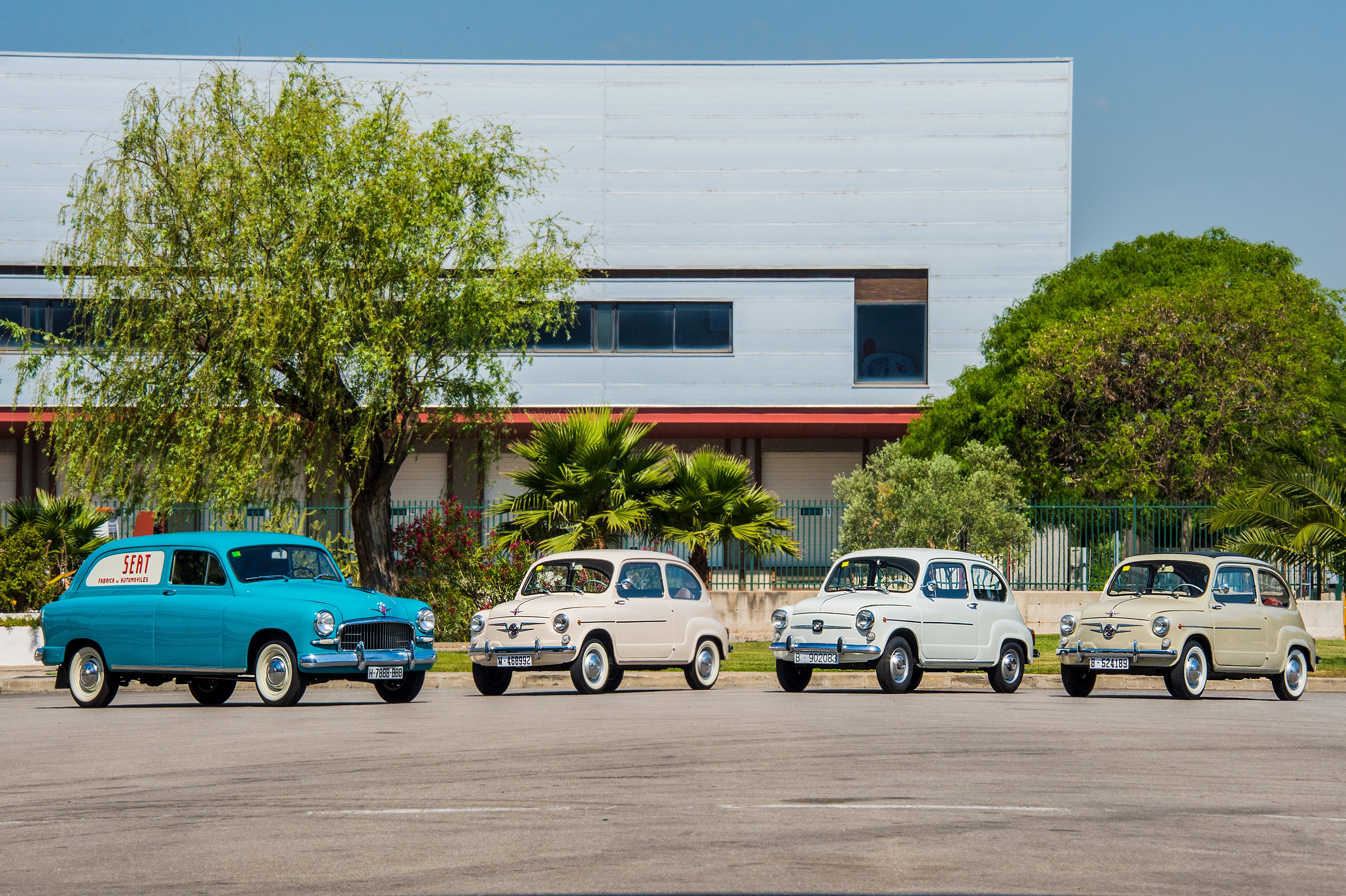 Four Seat cars in front of a building HD Wallpaper