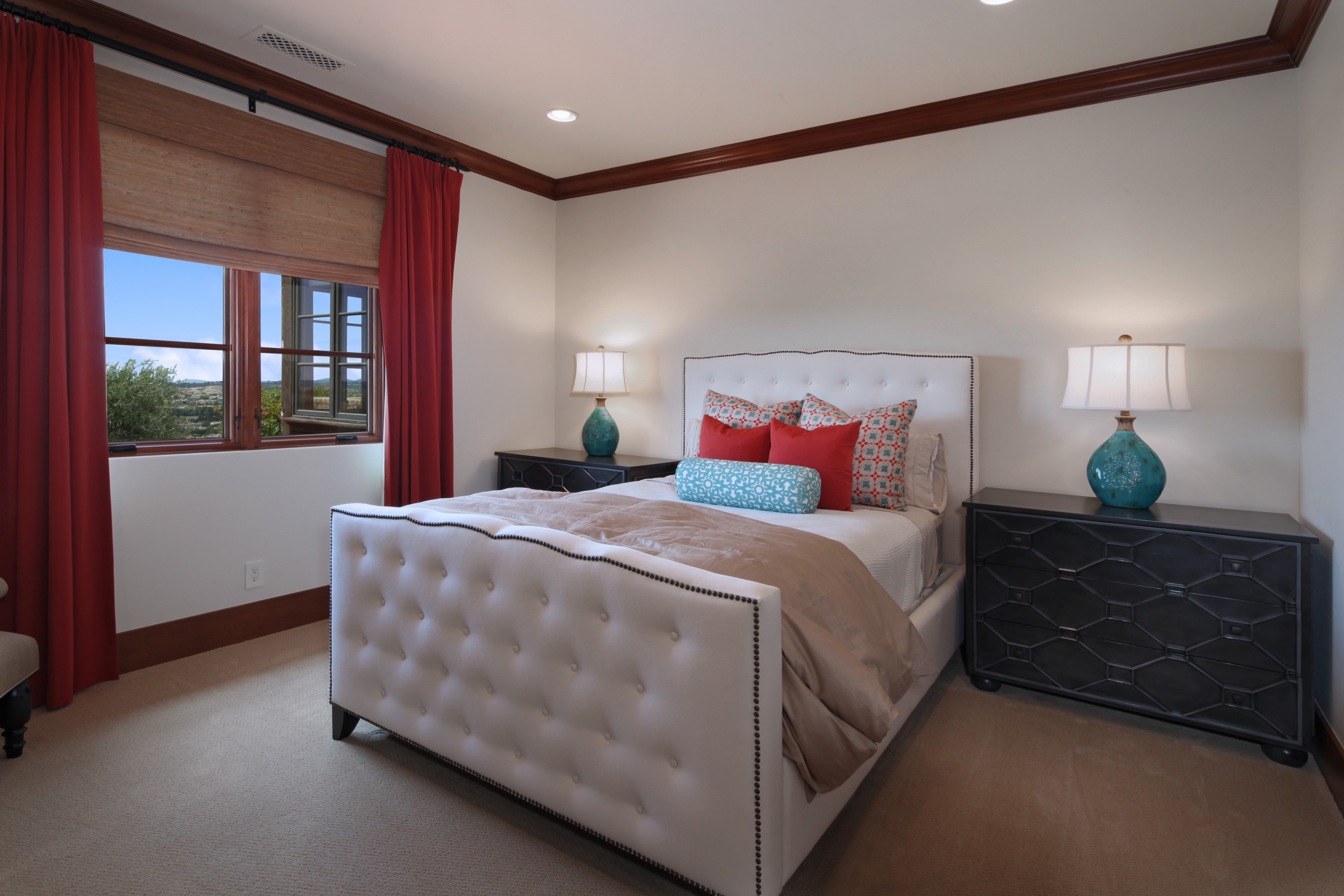 Bedroom with white tufted bed and red curtains HD Wallpaper