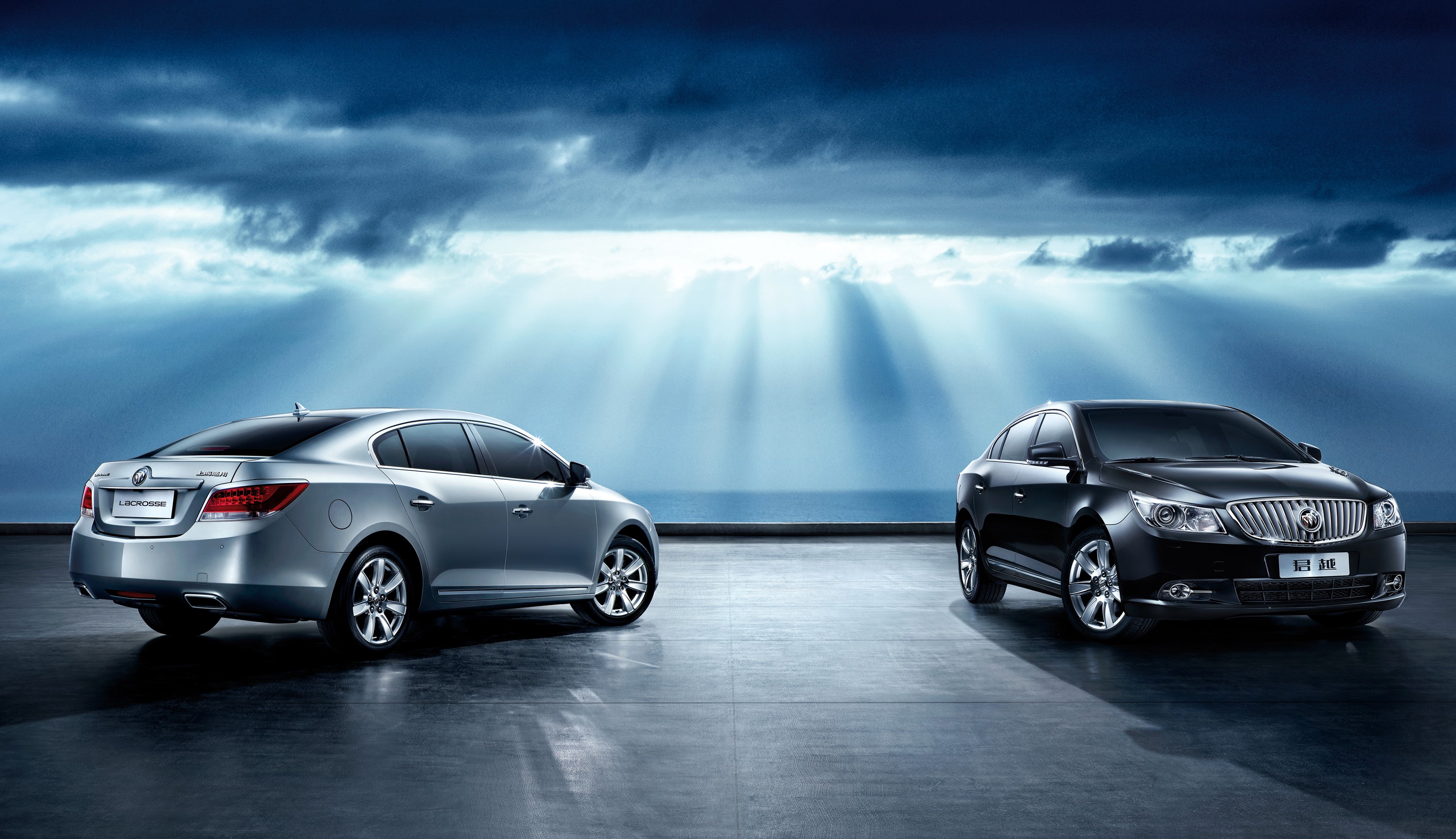 Two Buick LaCrosse cars with sun rays HD Wallpaper