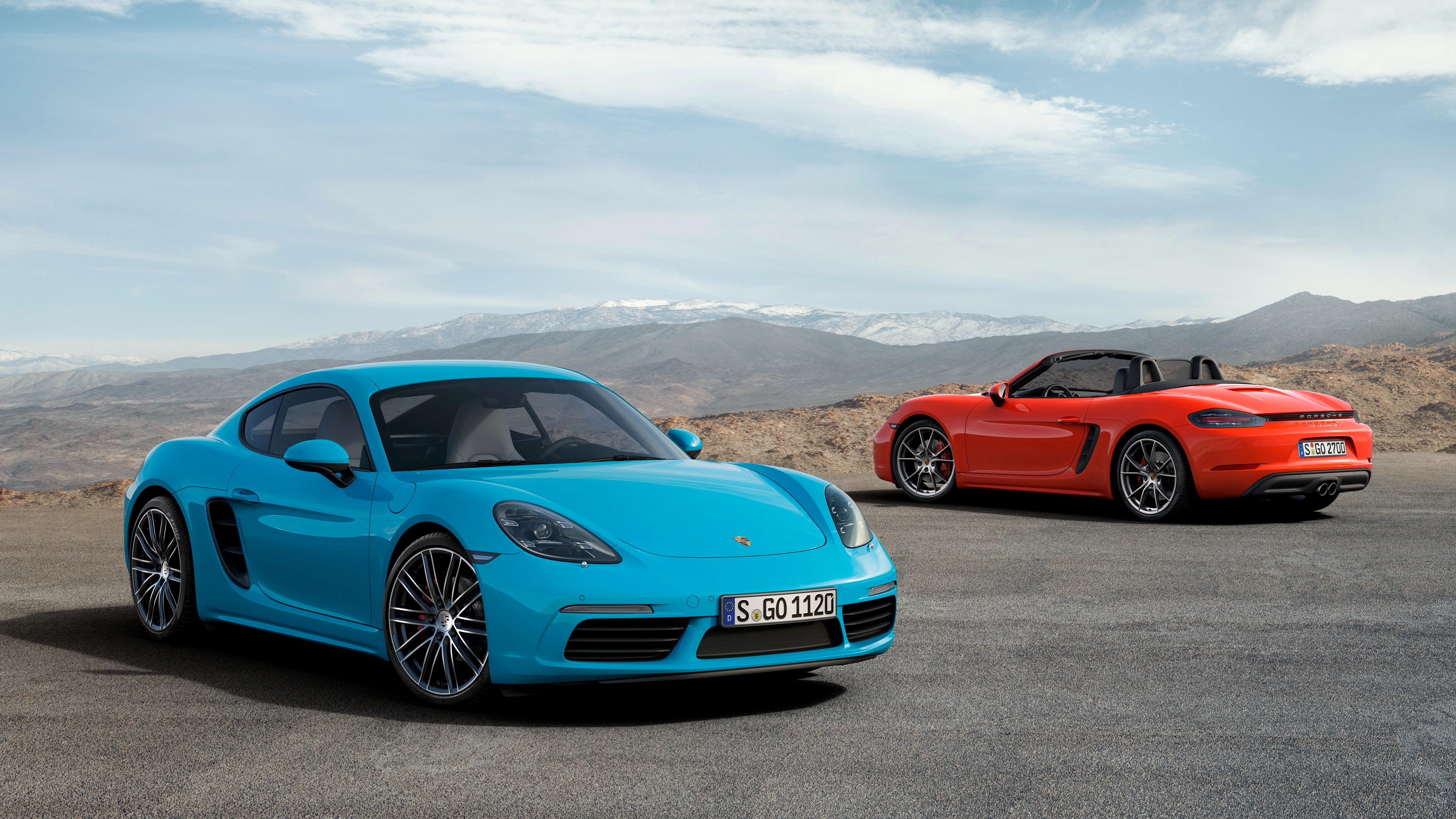 Two Porsche 718 Cayman S cars on a road HD Wallpaper