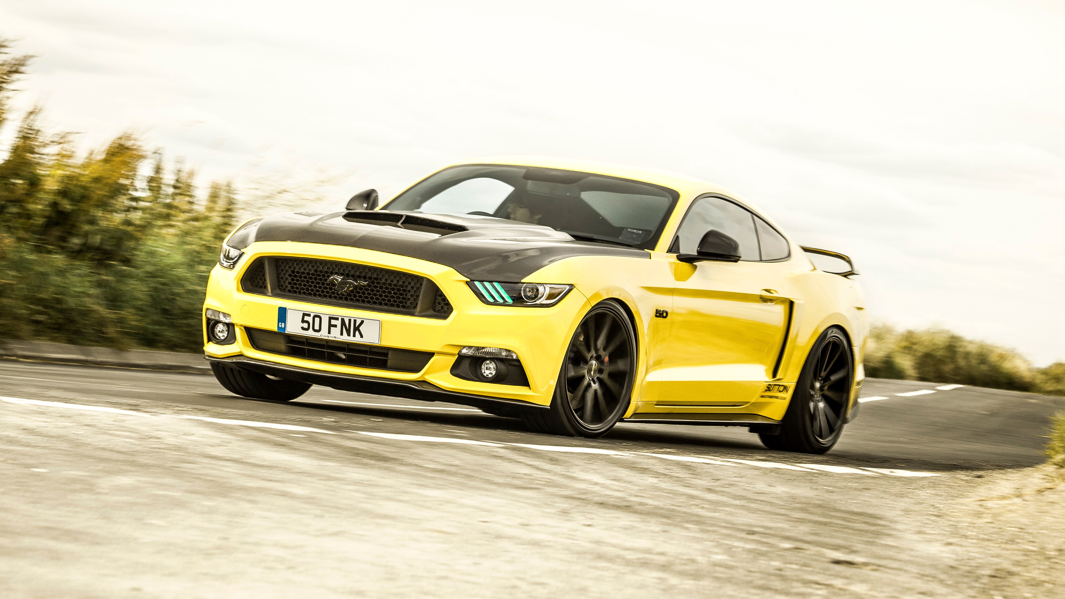 Yellow 2016 Clive Sutton Mustang CS700 on a road HD Wallpaper