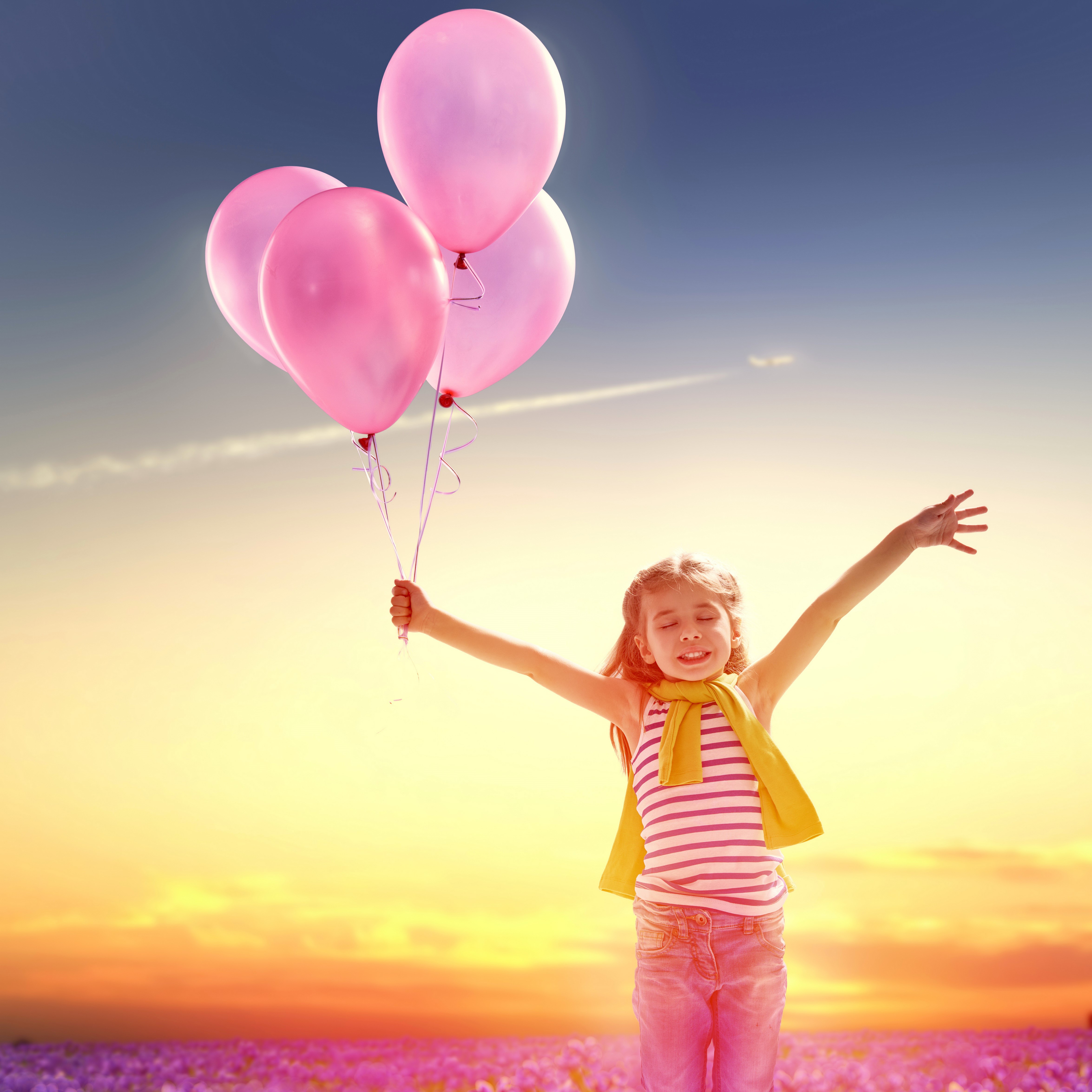 Girl holding pink balloons in a field HD Wallpaper