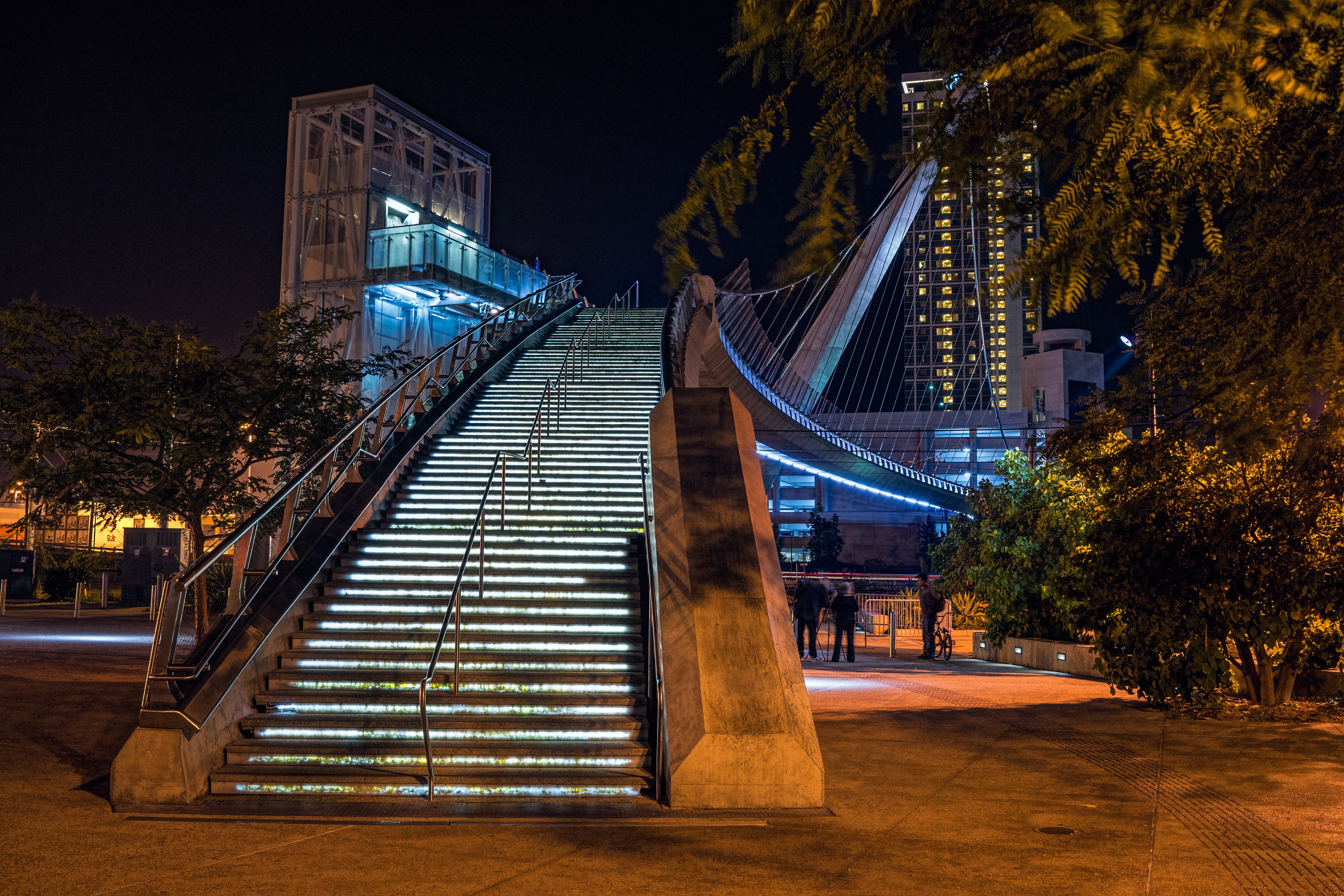 Pedestrian bridge with illuminated stairs at night in San Diego HD Wallpaper