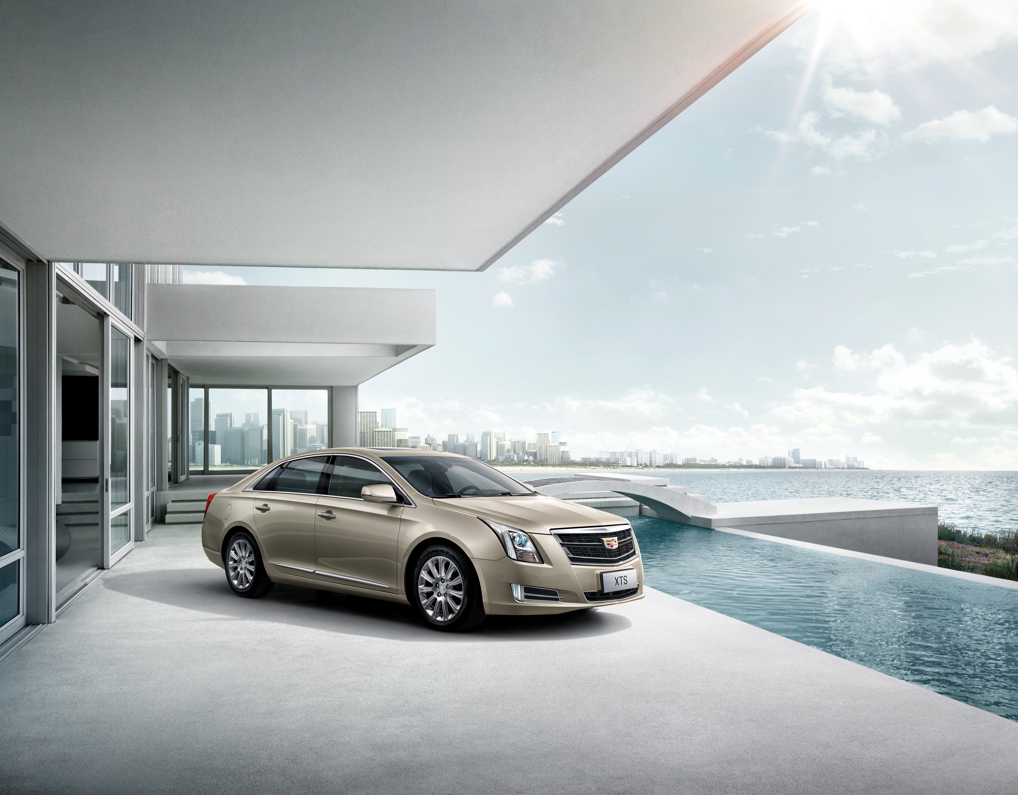 Cadillac XTS parked by a modern house and infinity pool HD Wallpaper