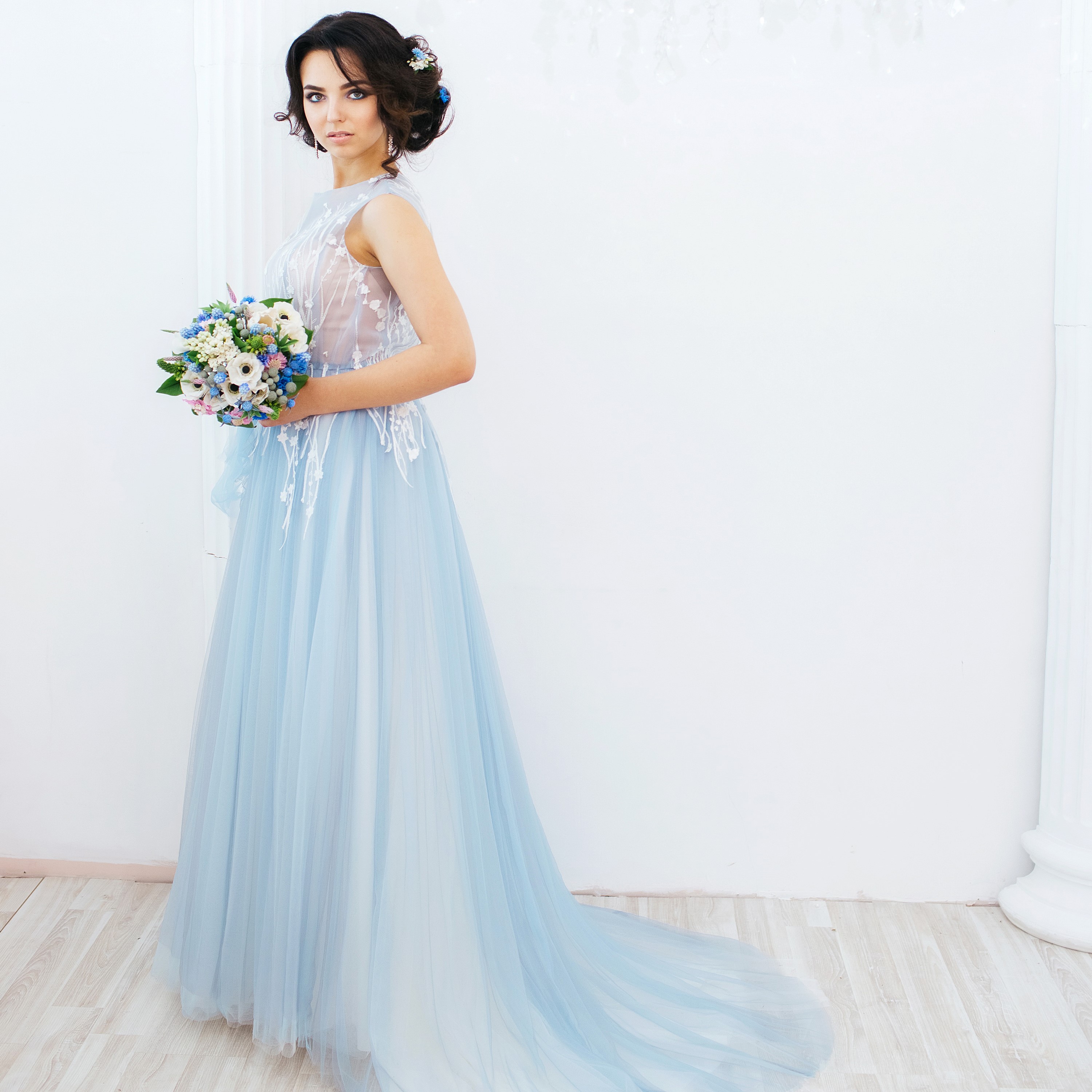 Brunette woman in a light blue dress holding a bouquet HD Wallpaper