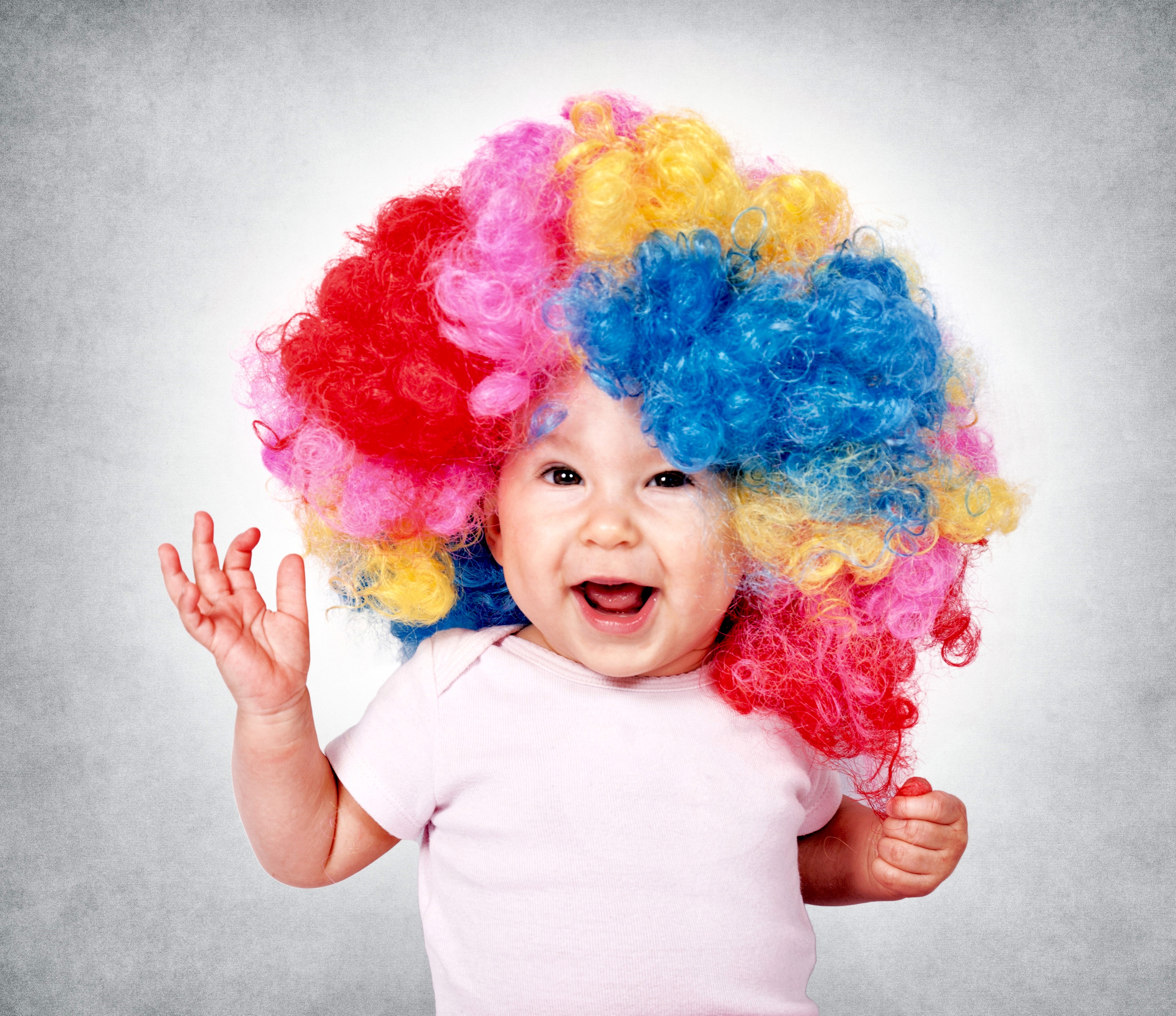Baby wearing a colorful clown wig HD Wallpaper