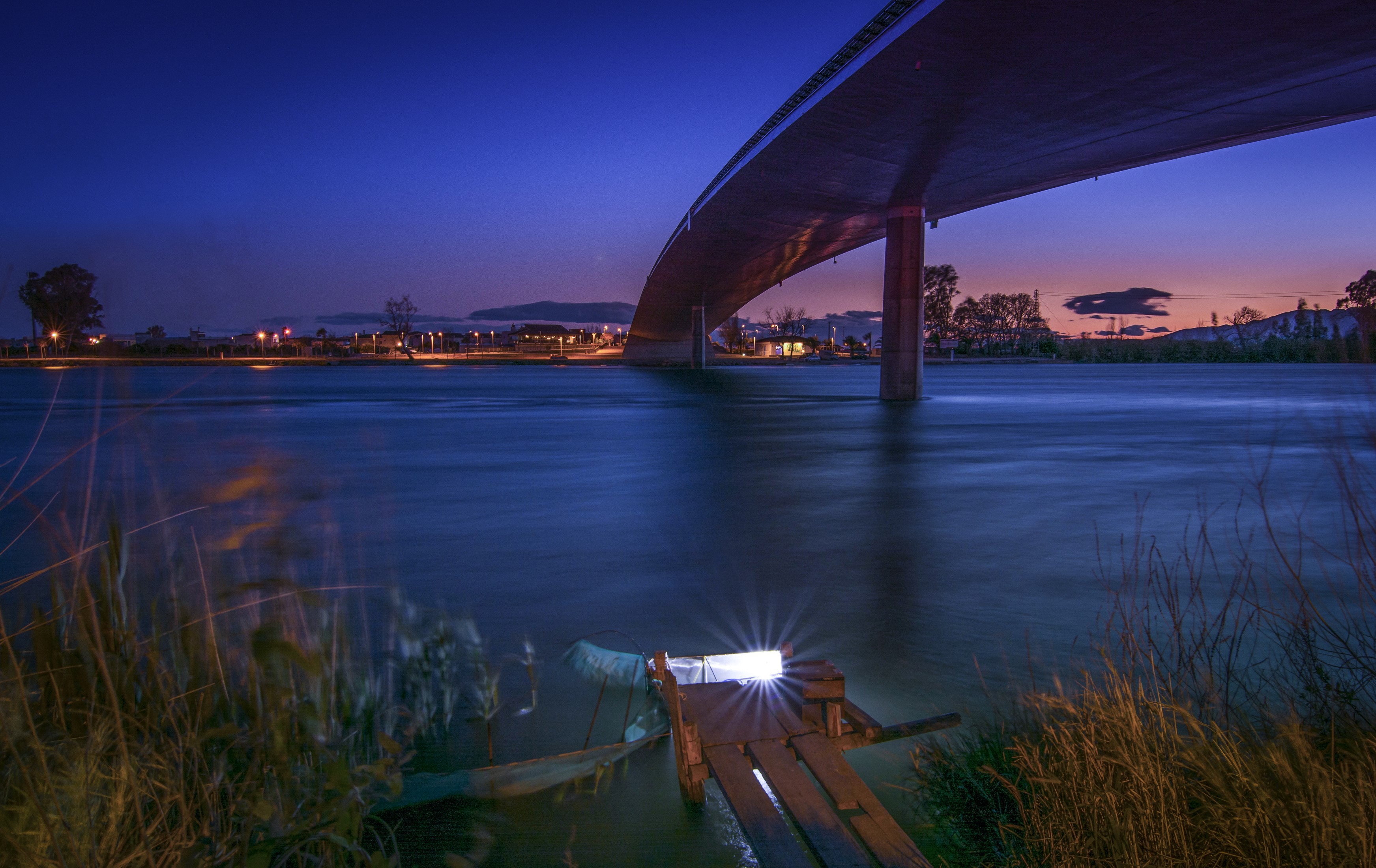 Bridge over river at dusk in Delta del Ebro, Spain HD Wallpaper