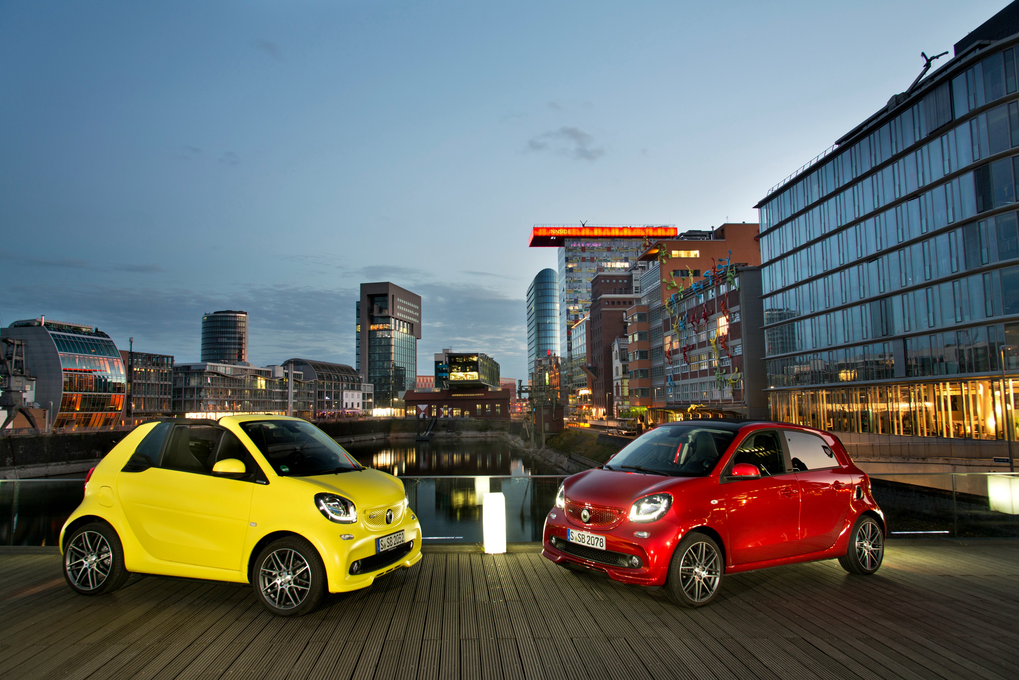 Two Smart Cars in City at Dusk HD Wallpaper