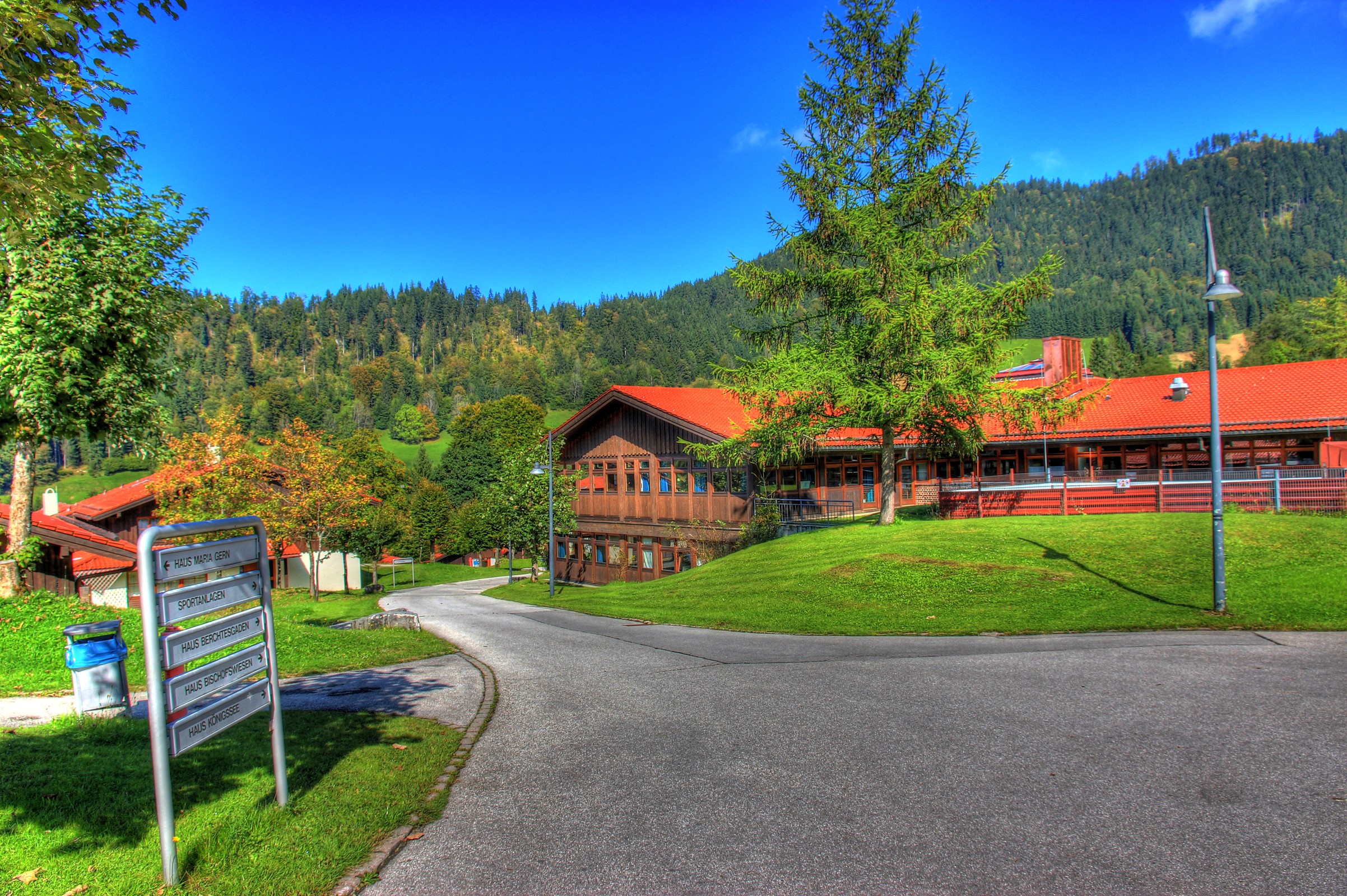 Road leading to wooden buildings in Berchtesgaden, Germany HD Wallpaper