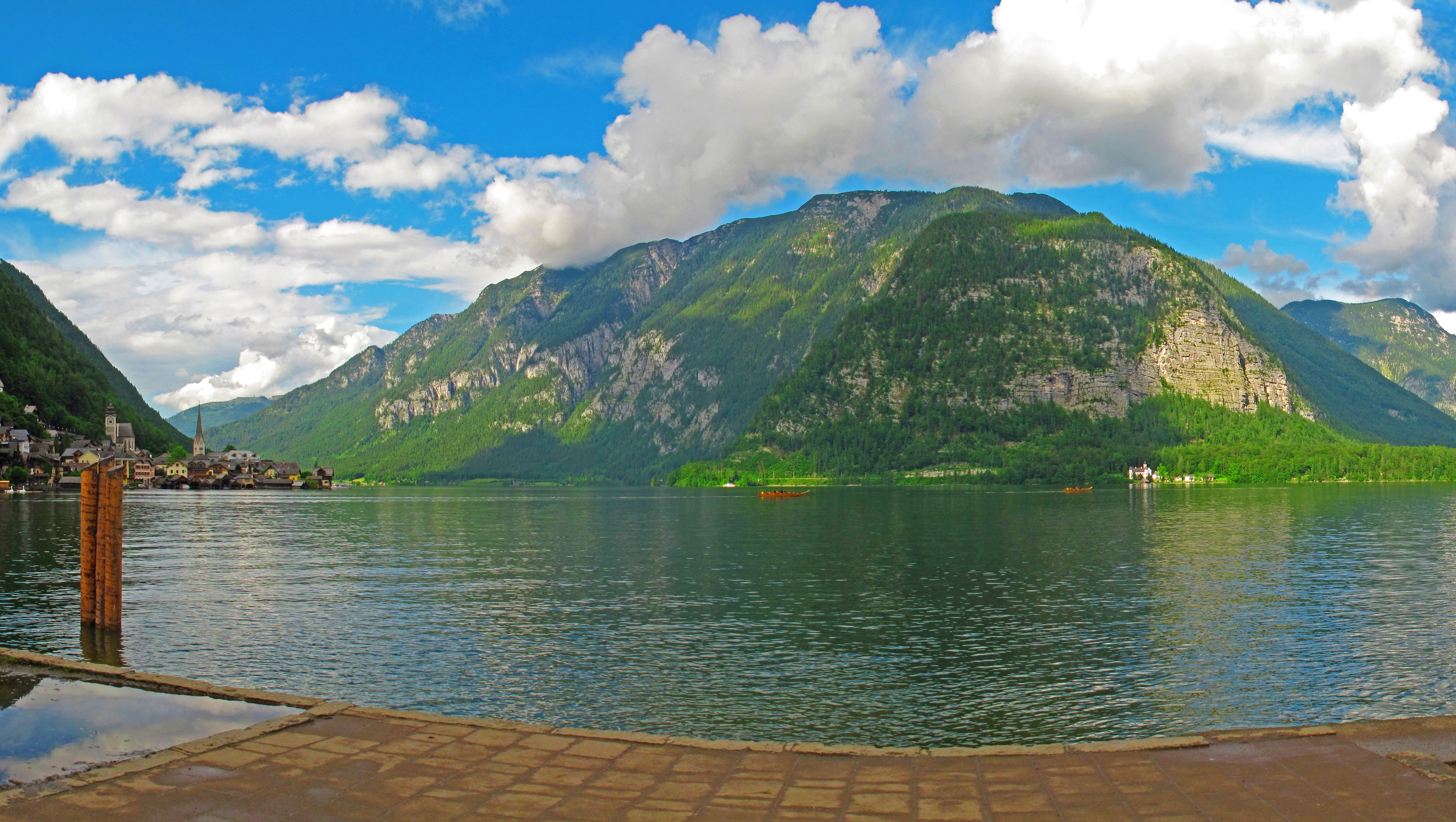 Hallstatt village on a lake with mountains and clouds HD Wallpaper