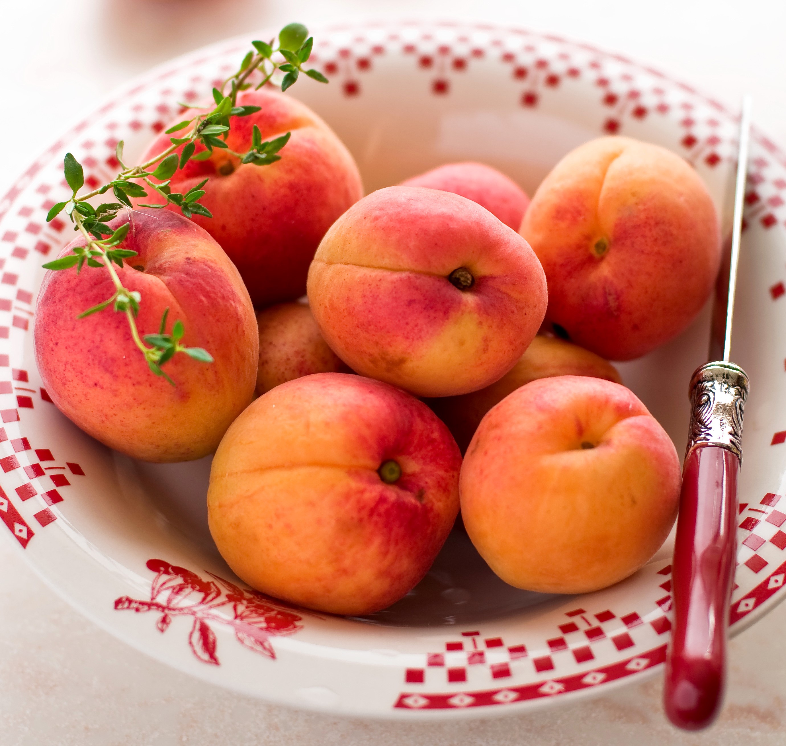 Apricots in a bowl with a knife and thyme HD Wallpaper