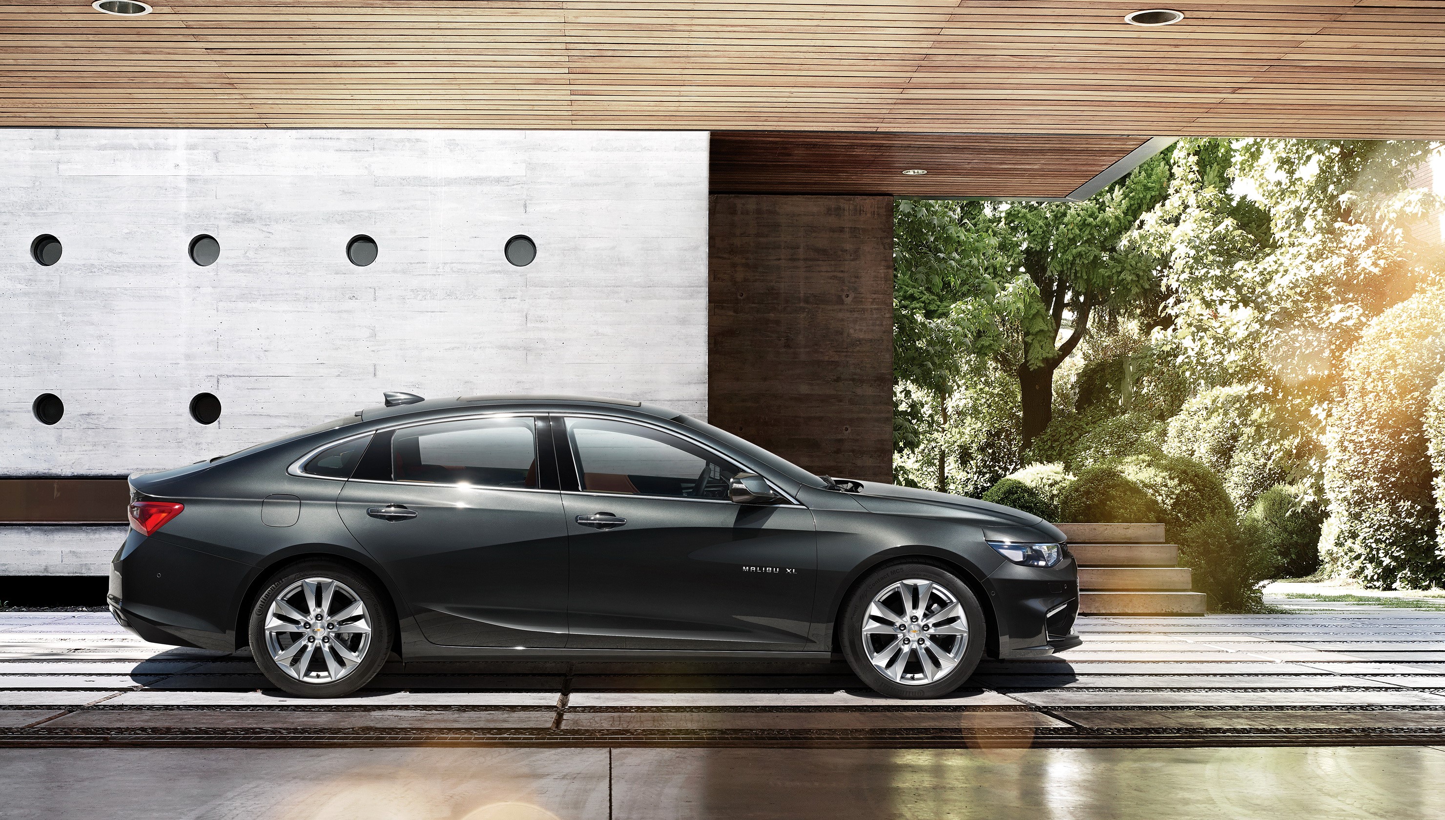 Chevrolet Malibu XL parked in modern architectural setting HD Wallpaper